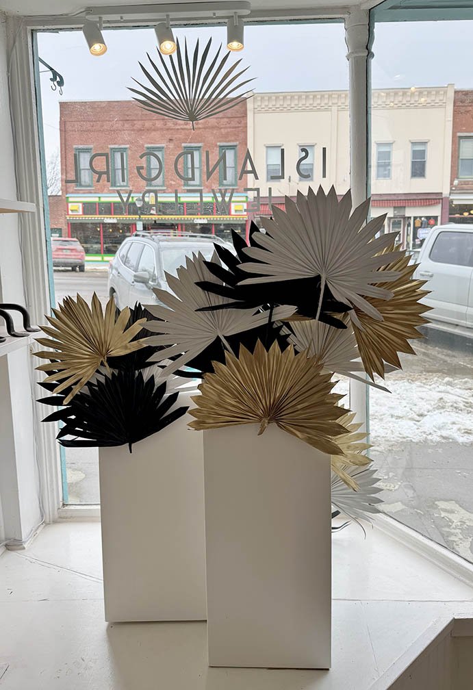 Right window interior view of palms & pedestals window display 