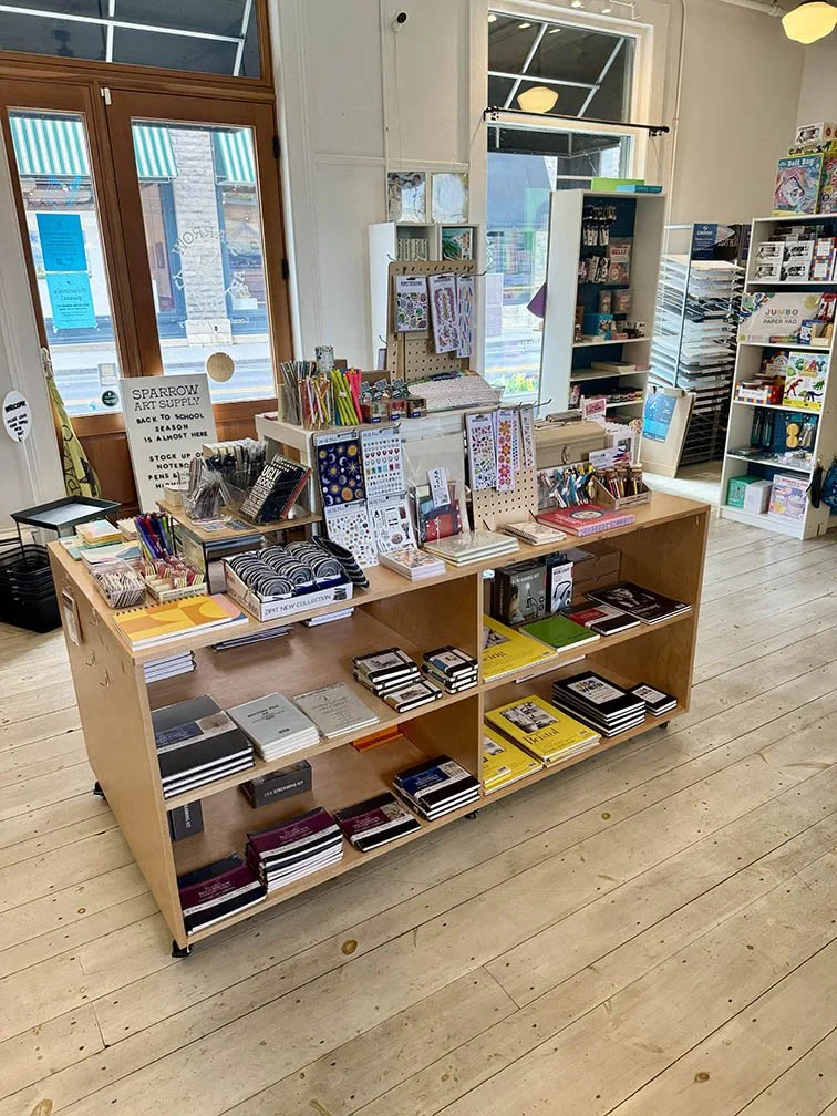 Back view of front table merchandised with more notebooks - June refresh 2025