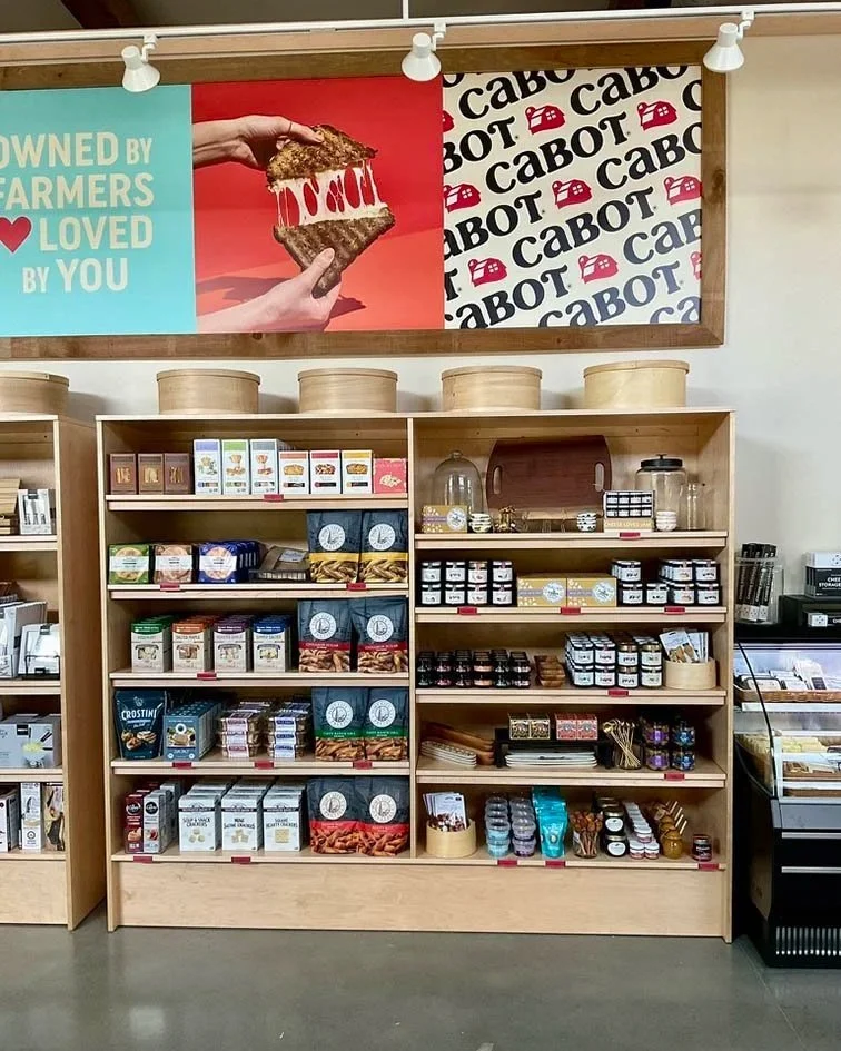Shelving at Cabot Creamery store merchandised with jams and crackers