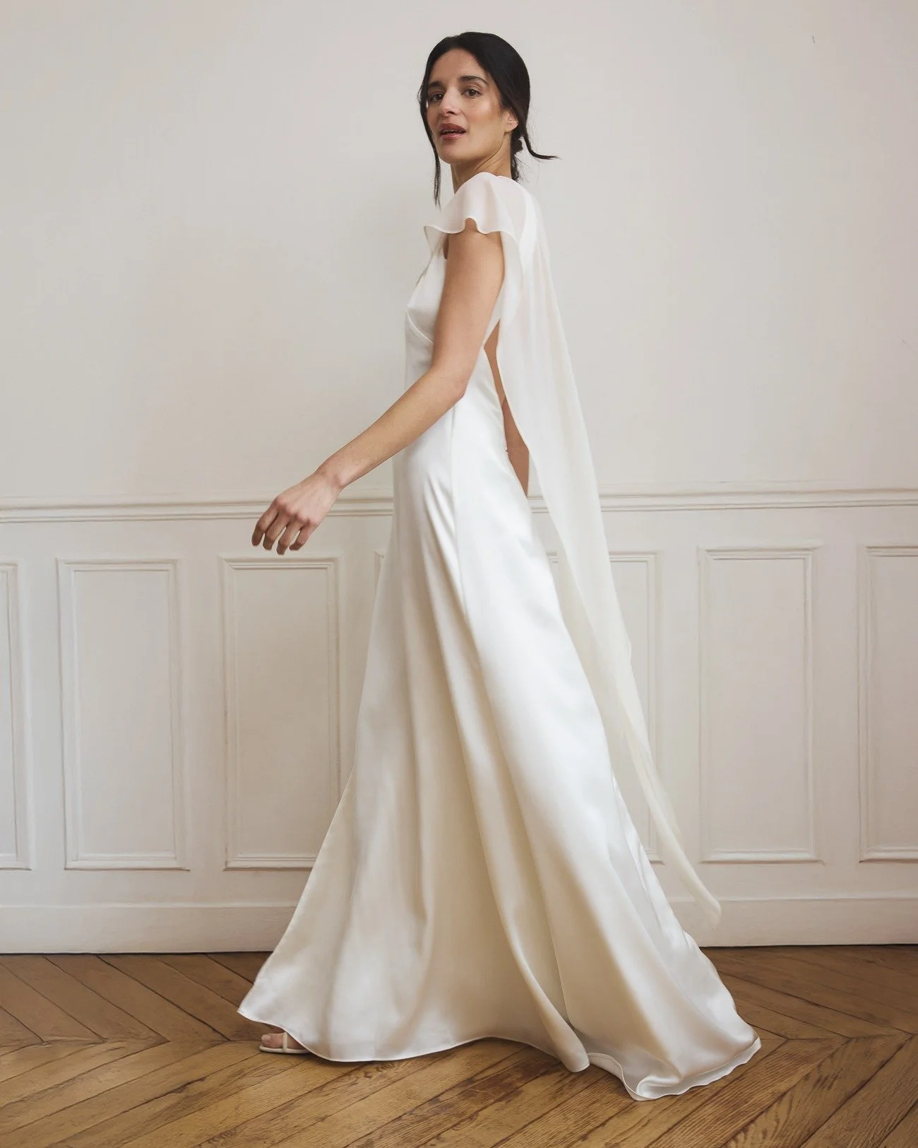 MARGOT &mdash; for the bride who loves a classic silhouette with a twist.

Cut in fluid satin and finished with a silk georgette scarf, designed to move with you. Wear it draped as a cape or thrown back effortlessly as a scarf &mdash; playful, versat