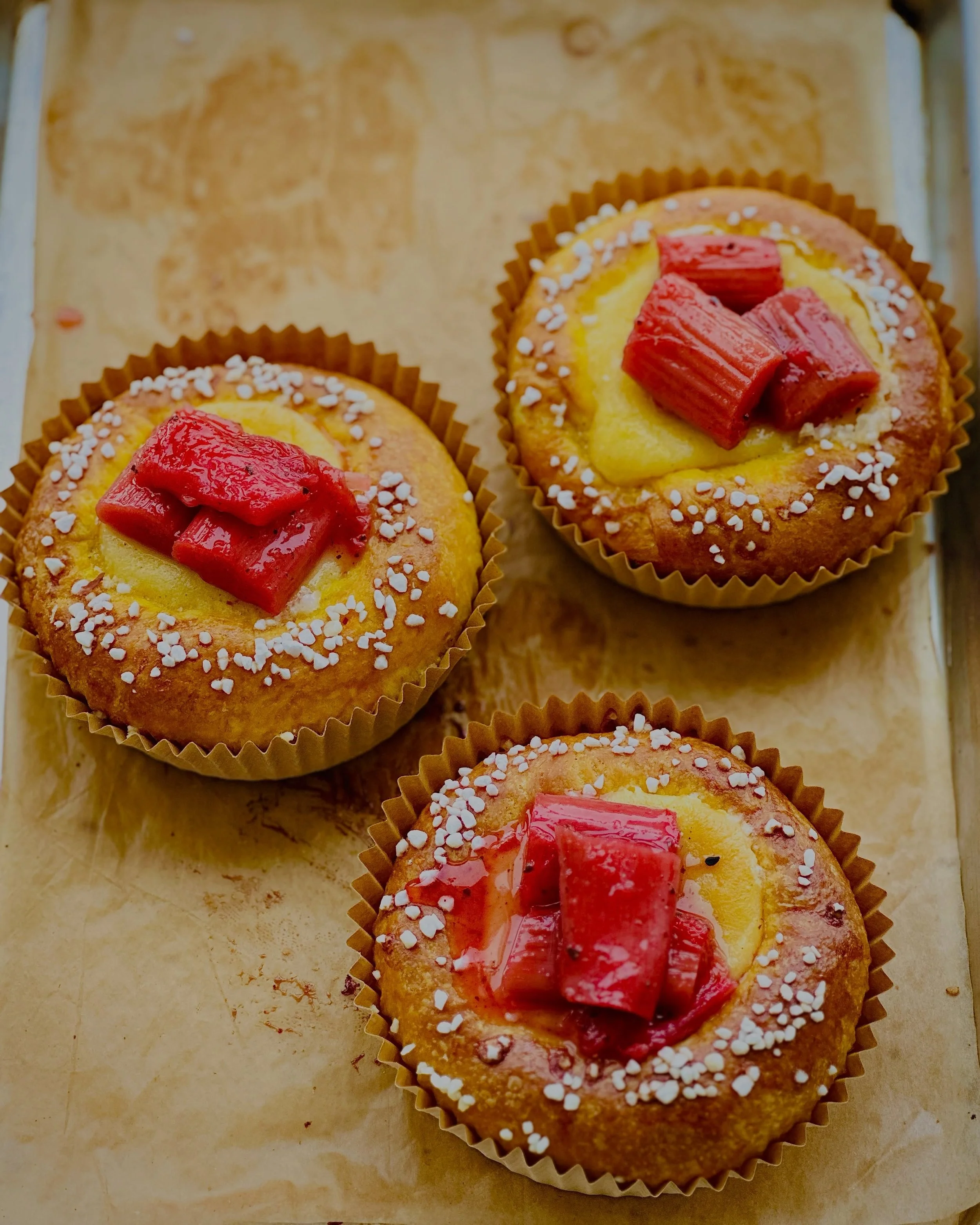 SAFFRON RHUBARB BRIOCHE

Our signature plush brioche infused with saffron and rosewater, filled with tart rhubarb jam and warmly spiced ginger honey pastry cream. Finished with ginger + rosewater poached rhubarb, rose petals, and pearl sugar for the 