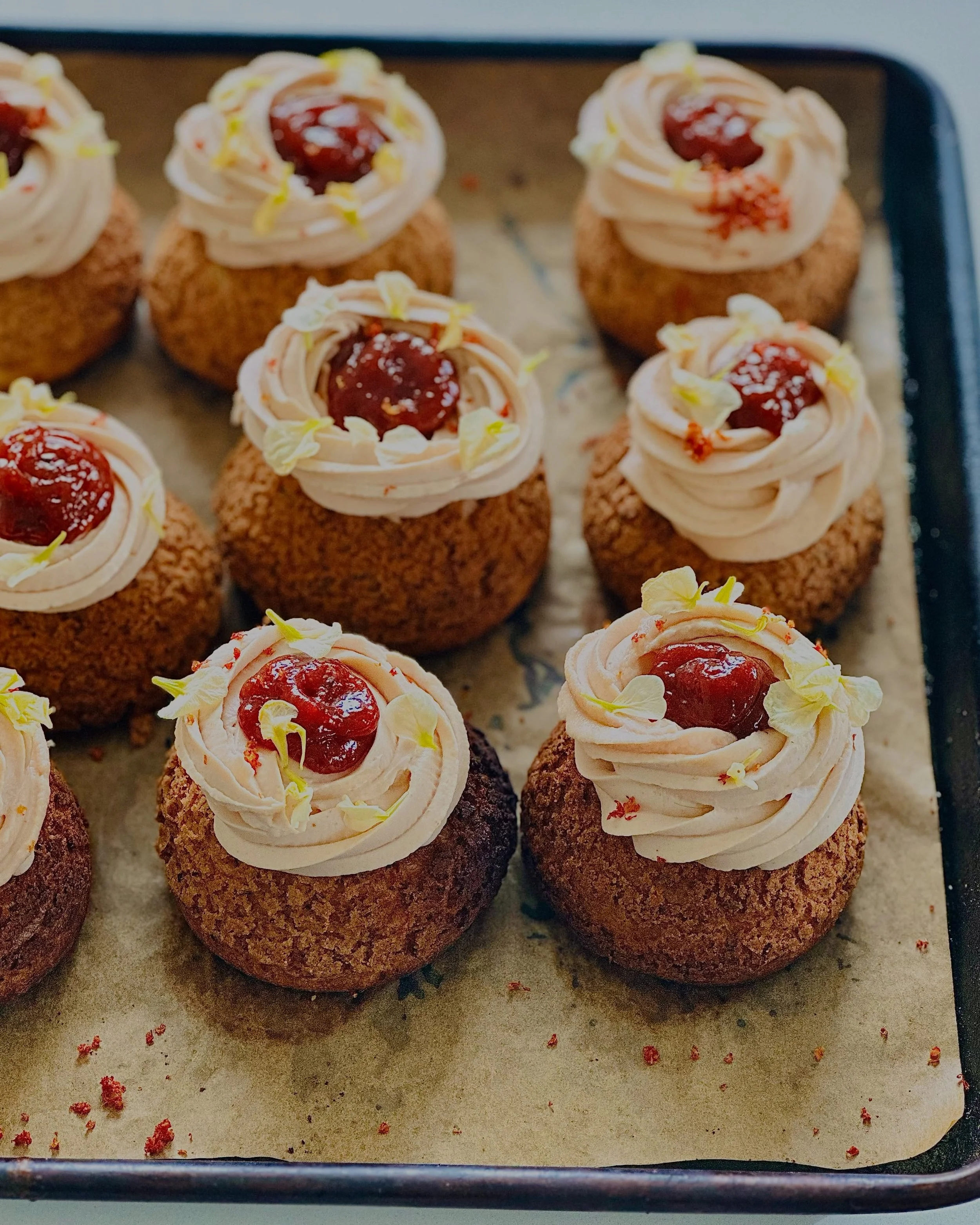 It returns this summer

Every summer had its rituals.

Mine always circled back to guava and chile.
Sun-warmed fruit. A hit of heat. Sticky fingers before the day was done.

That memory became the Guava Gochugaru Choux.

A choux built in layers:
guav