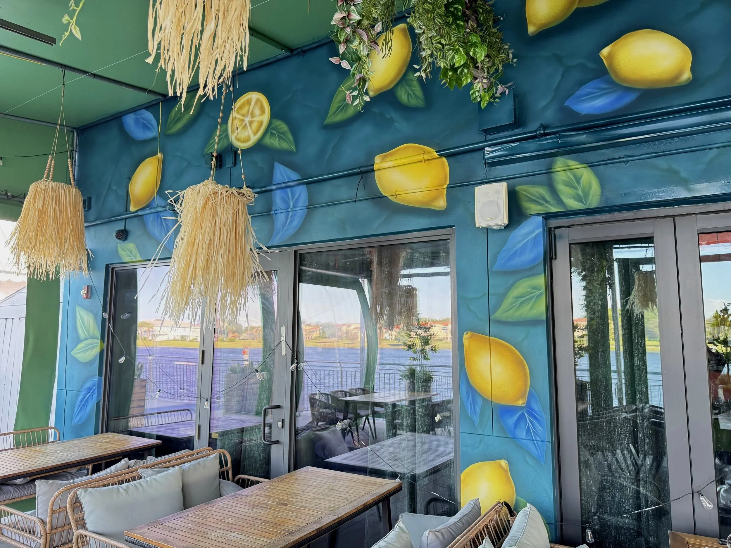 Realistic lemon mural painted around the doors of a restaurant terrace