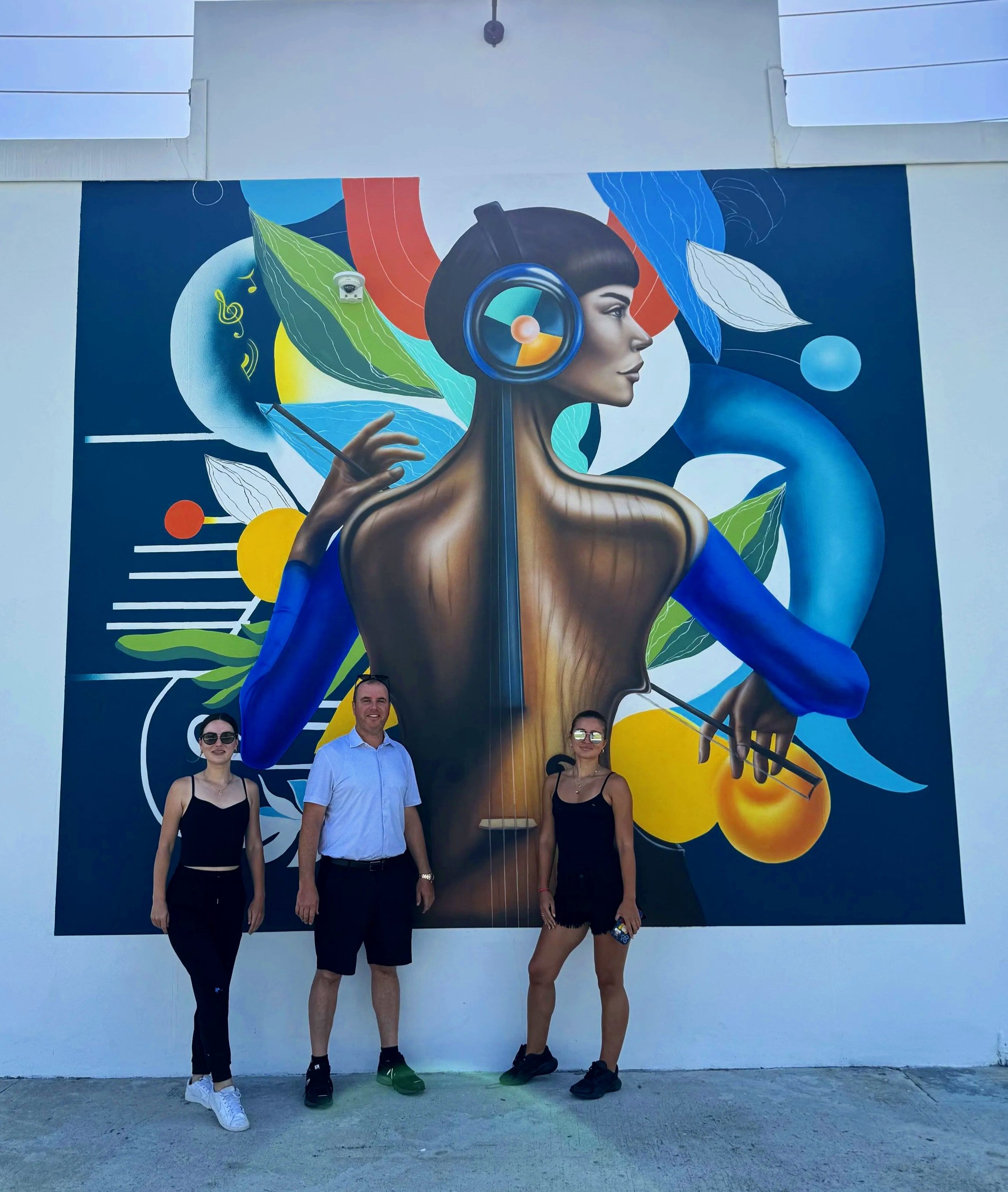 Completed Timeless Fusion mural with the artist and Thrive Art District project team