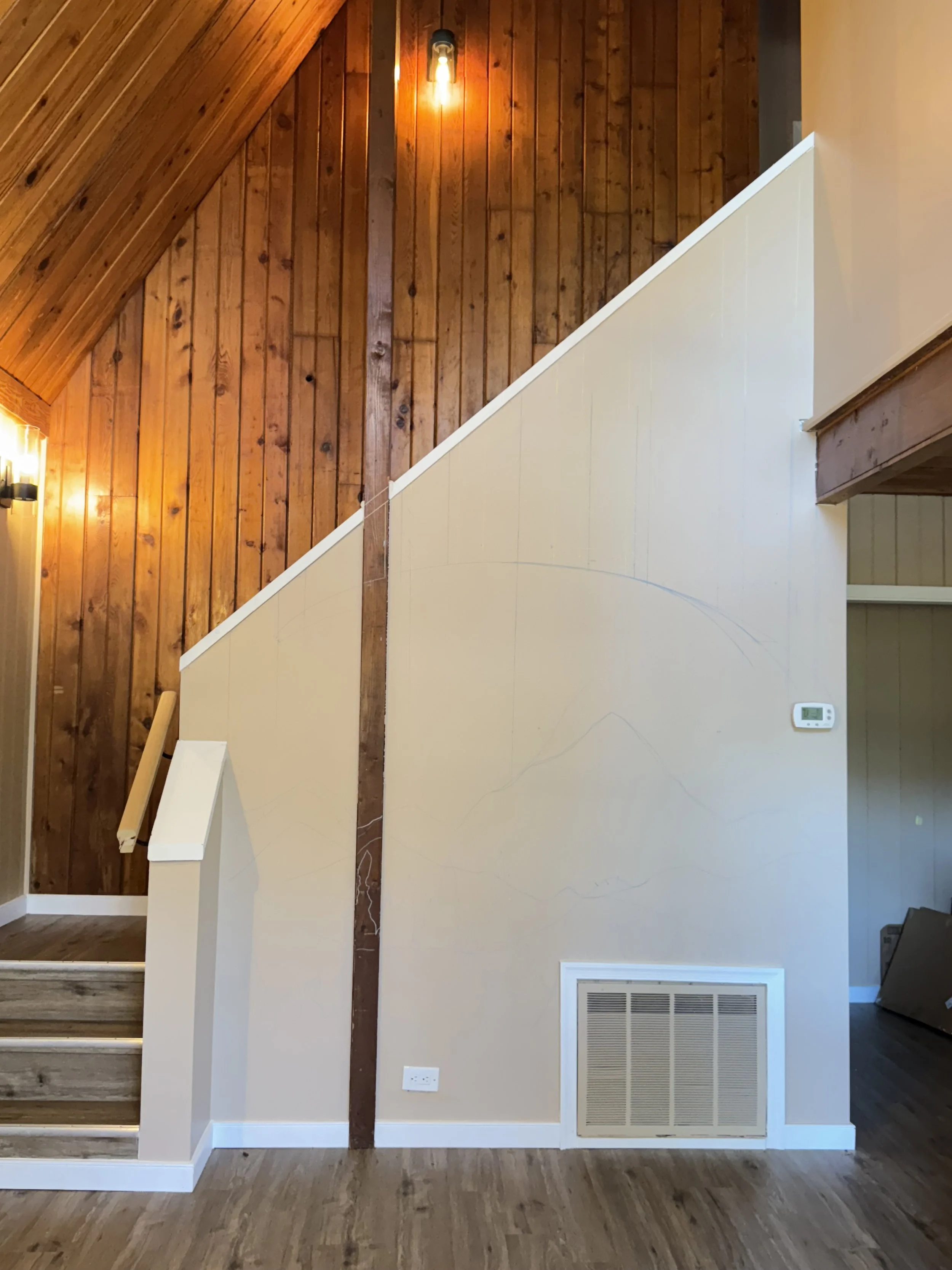 Blank stairway wall before the custom Virginia Airbnb mural
