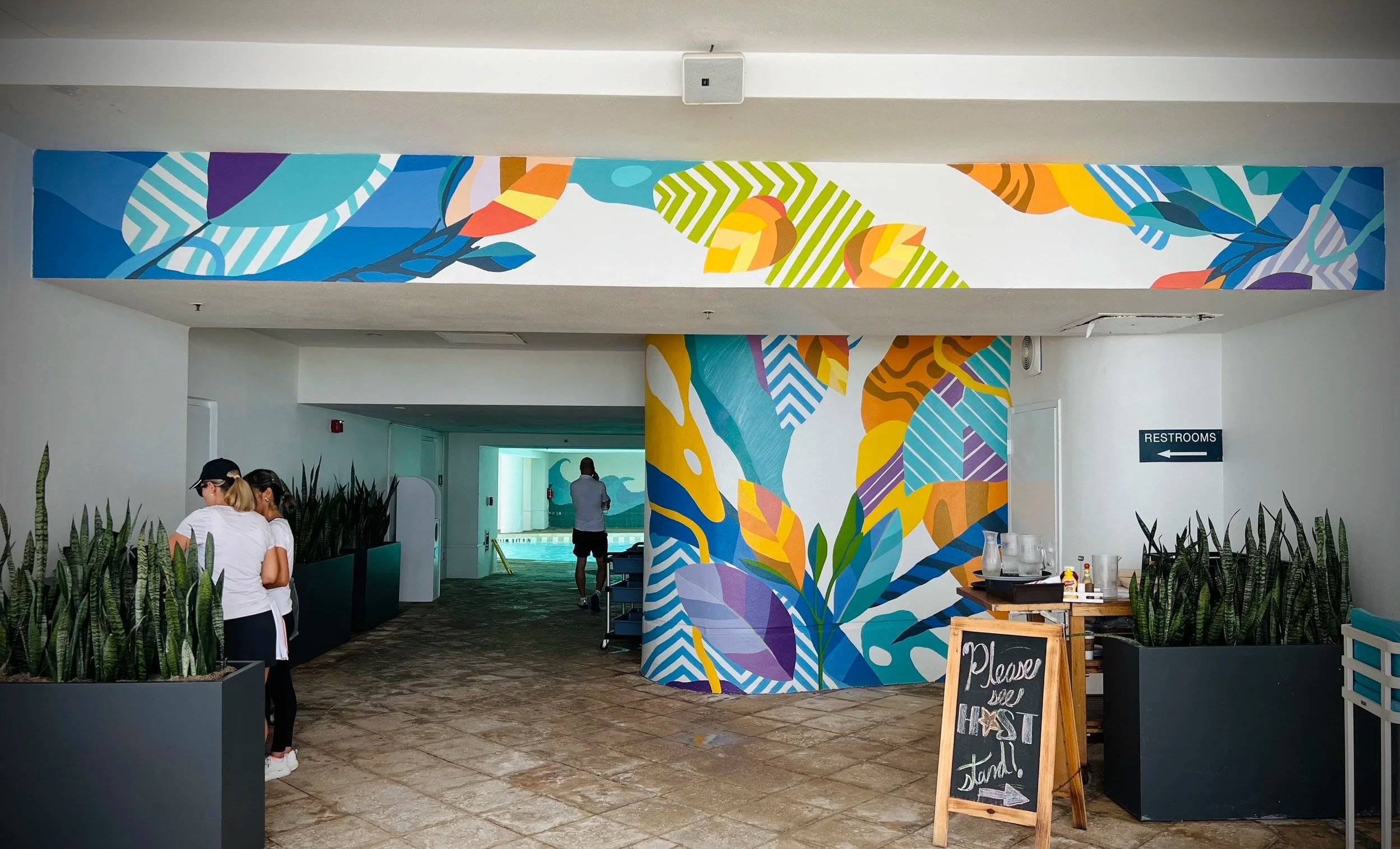 Colorful tropical mural wrapping the lobby walls of a Florida hotel