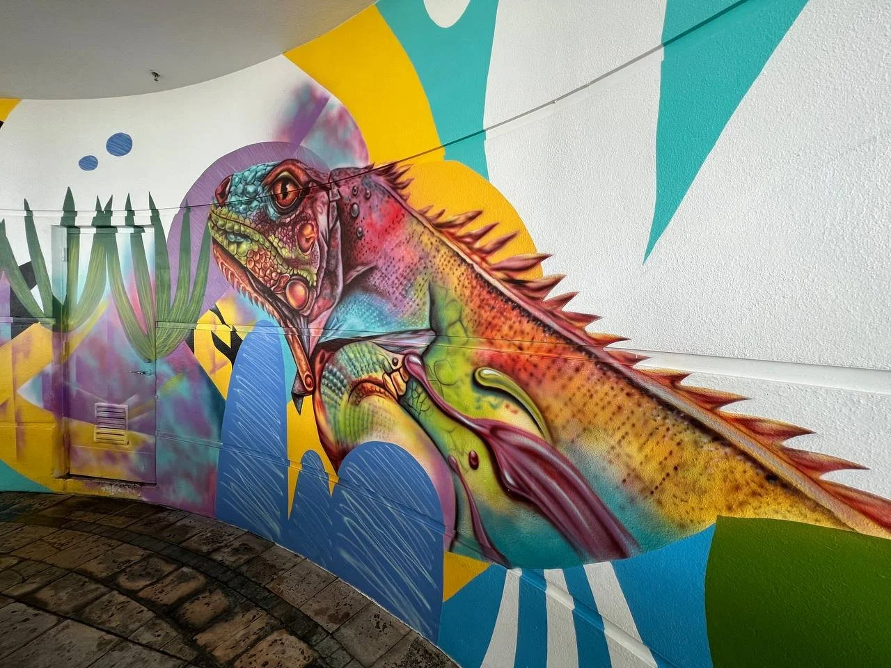 Detailed iguana painted with airbrush and acrylic in the Locals Only mural by Nargiza Dadabaeva.