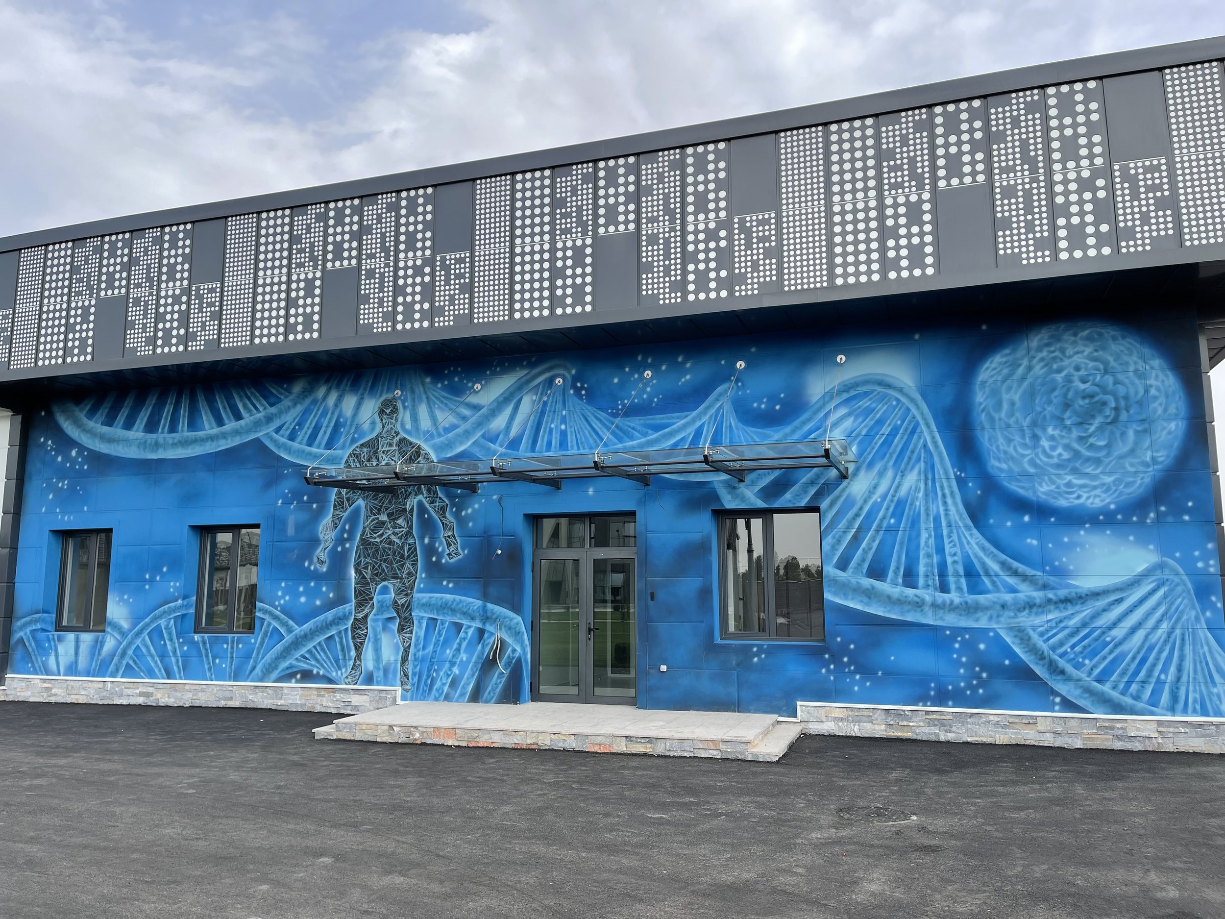 Blue DNA and science mural painted on a commercial building exterior