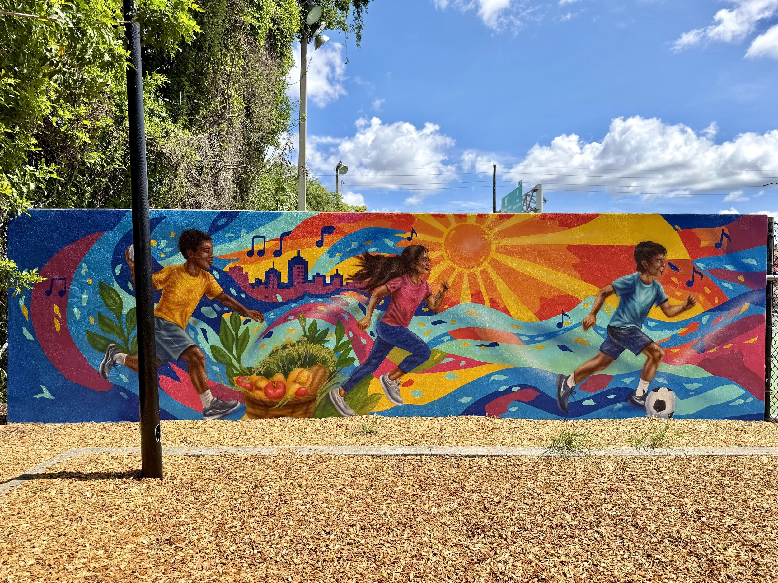 Colorful public art mural at the John H. Jackson Neighborhood Center Playground in Orlando, painted by Nargiza Dadabaeva.