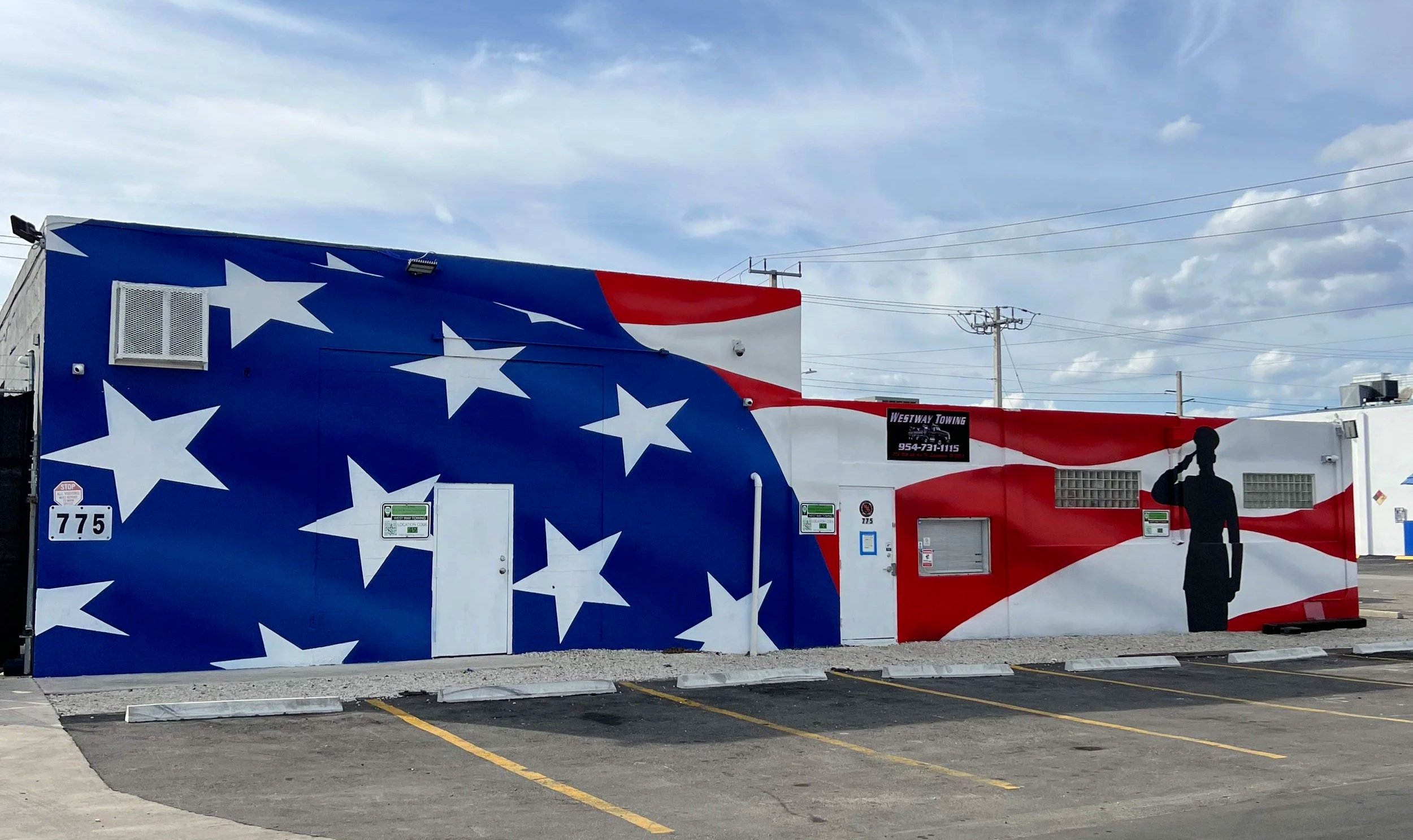 Patriotic stars and stripes mural painted across a commercial building in Florida