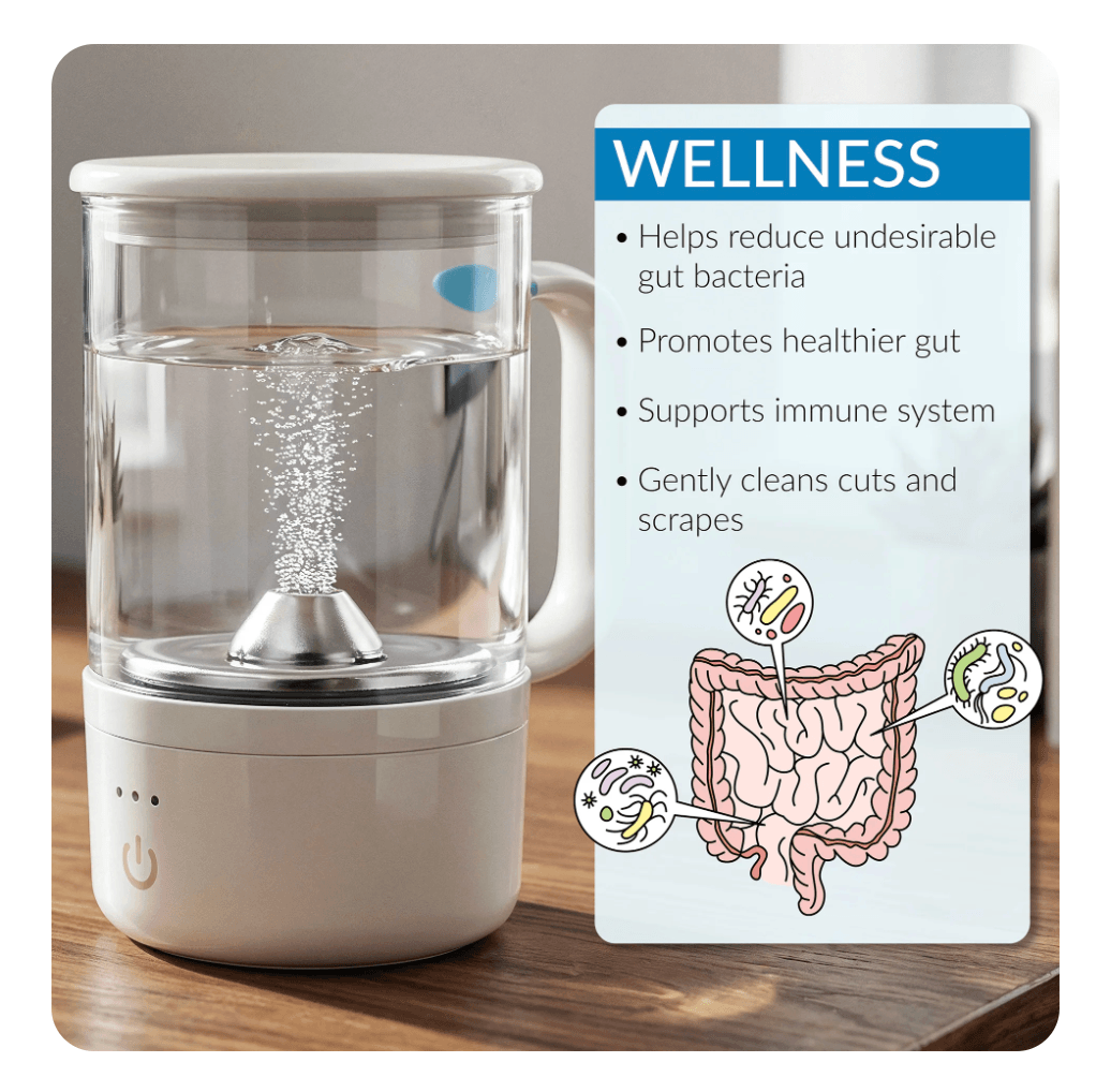 A small white water diffuser with a clear container filled with water, placed on a wooden surface. A wellness informational card with text and illustrations of the digestive system is beside it, highlighting benefits such as reducing gut bacteria, promoting healthier gut, supporting immune system, and gently cleaning cuts and scrapes.