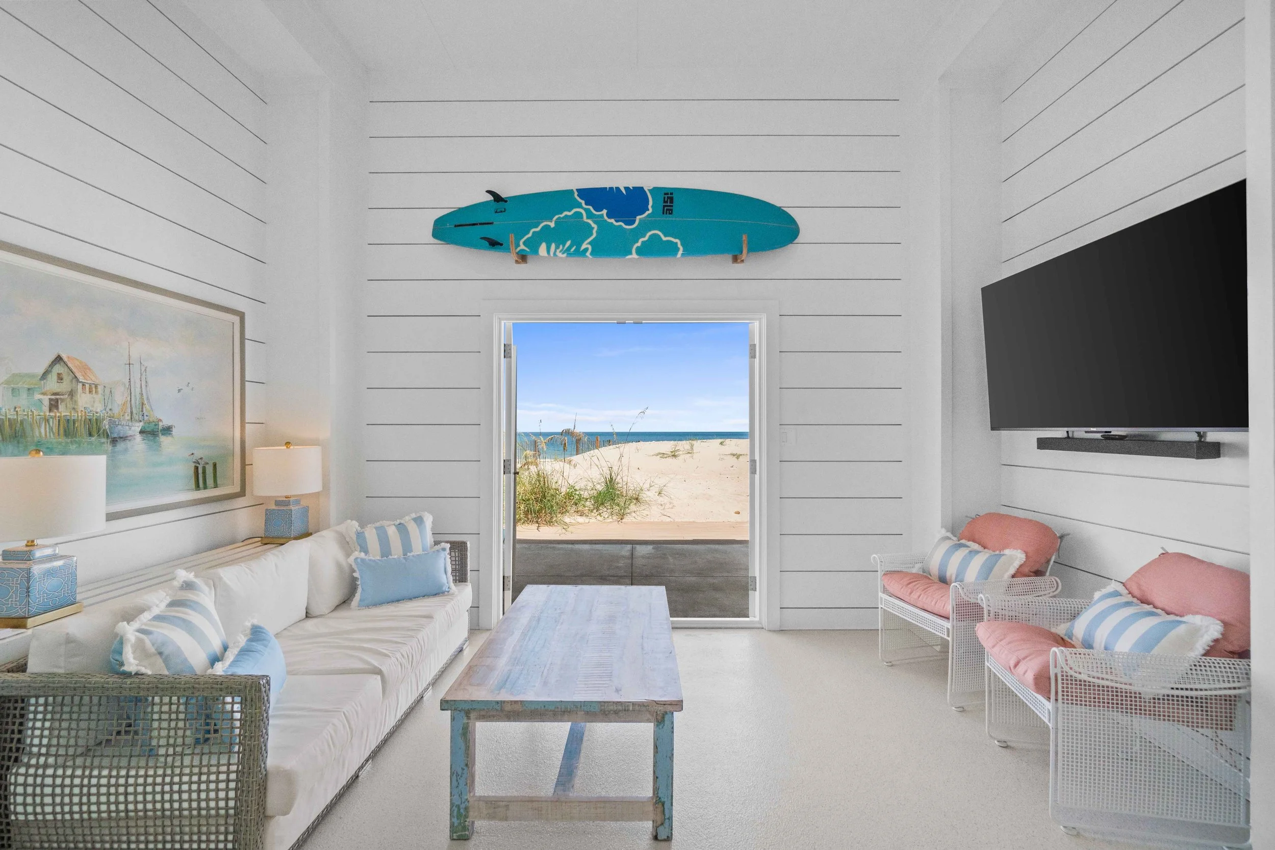 Real estate photo showcasing a downstairs hang-out space with ocean views 