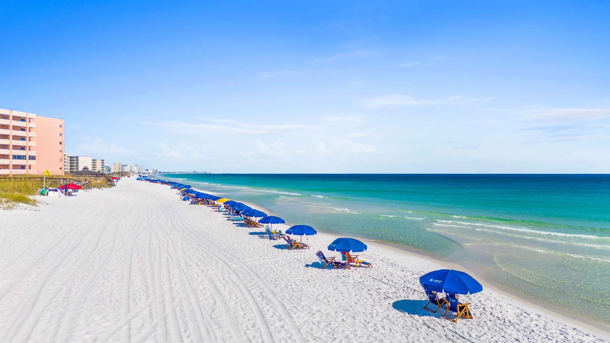 Beach drone photo of Destin Florida showcasing the emerald green water 