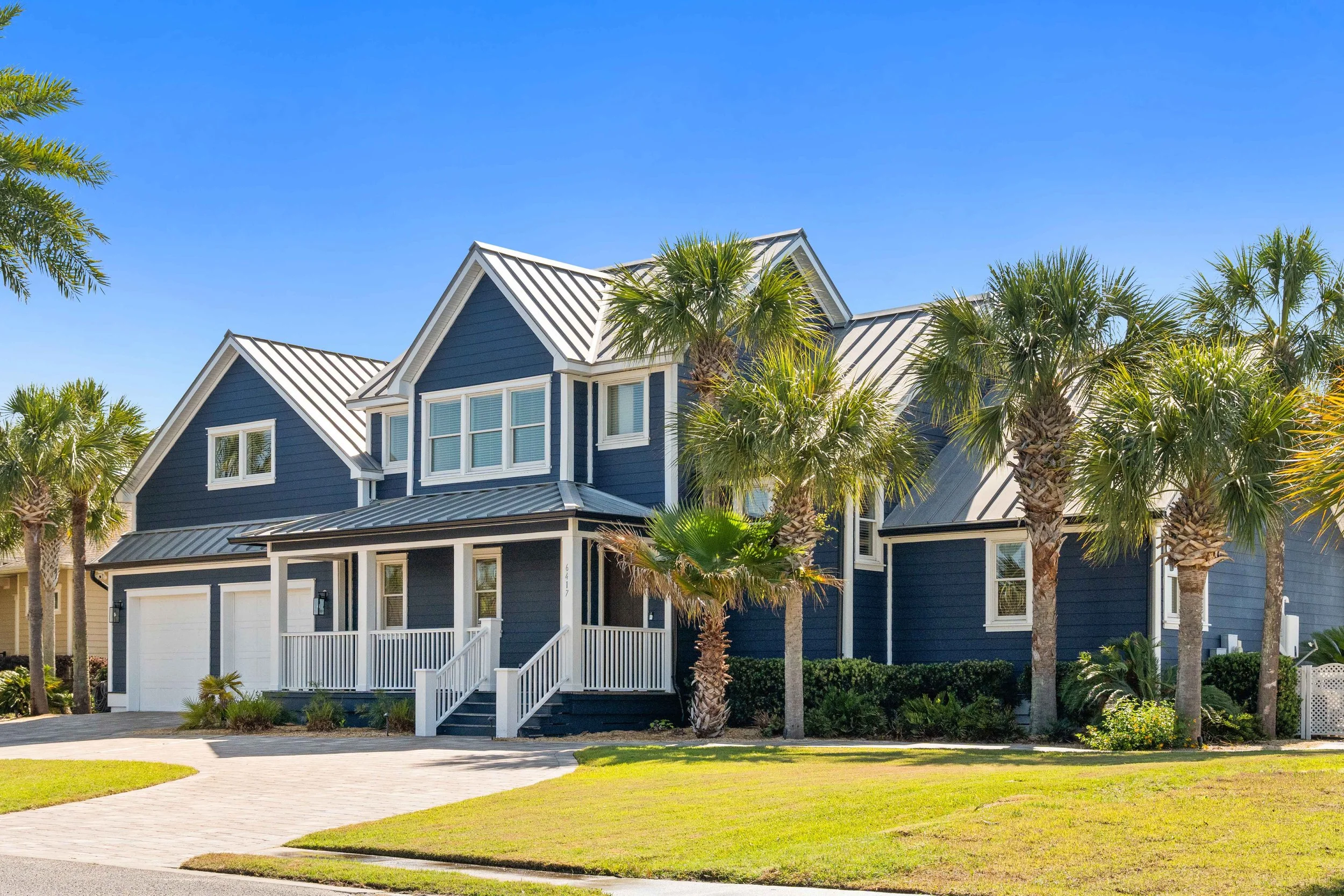 Drone photo of a real estate listing in Panama City Beach, showcasing a home with views of the Hathaway bridge and bay