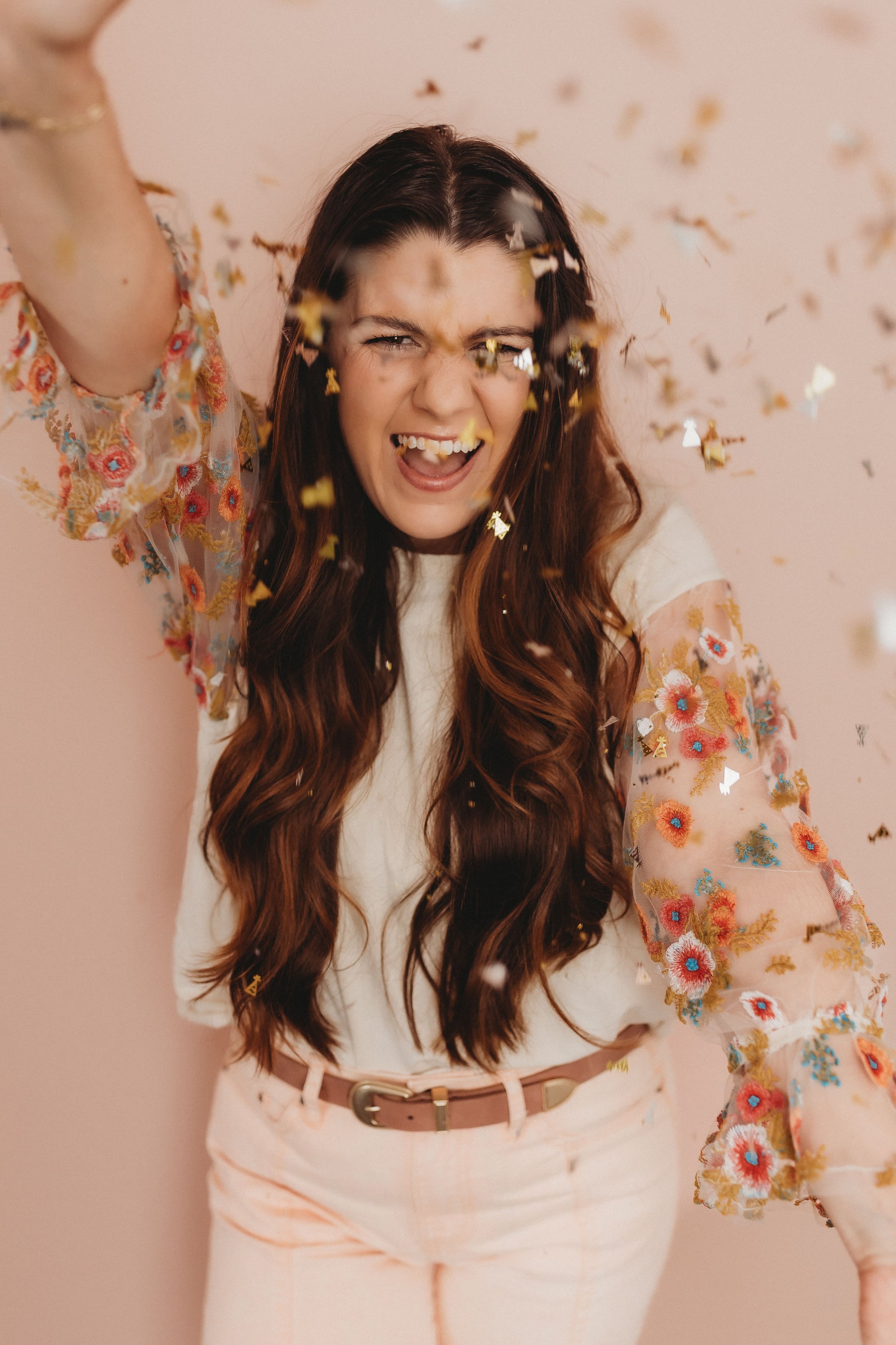  hannah smiles as she throws confetti during her brand photos 