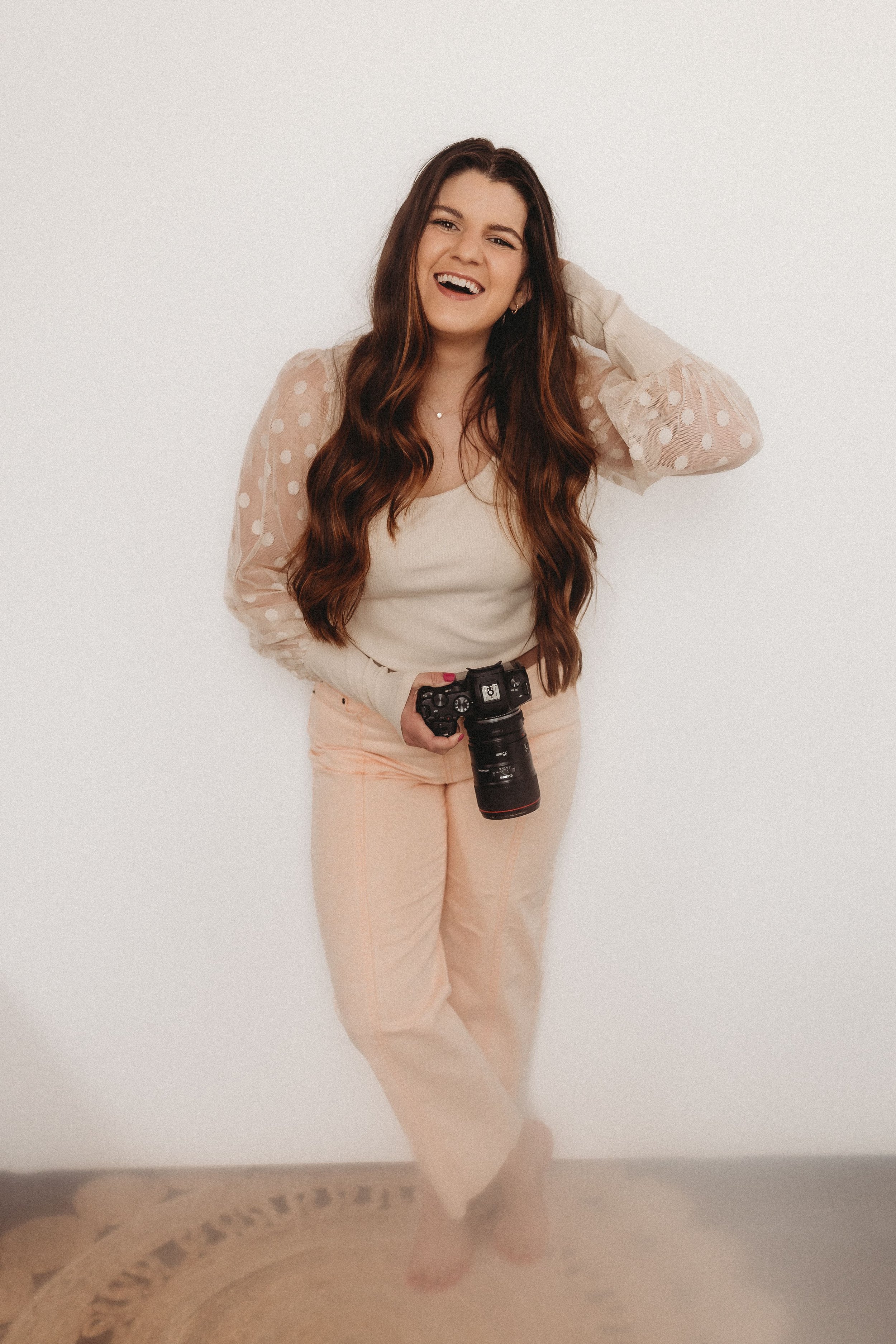  hannah laughs while holding her camera during her brand photos 