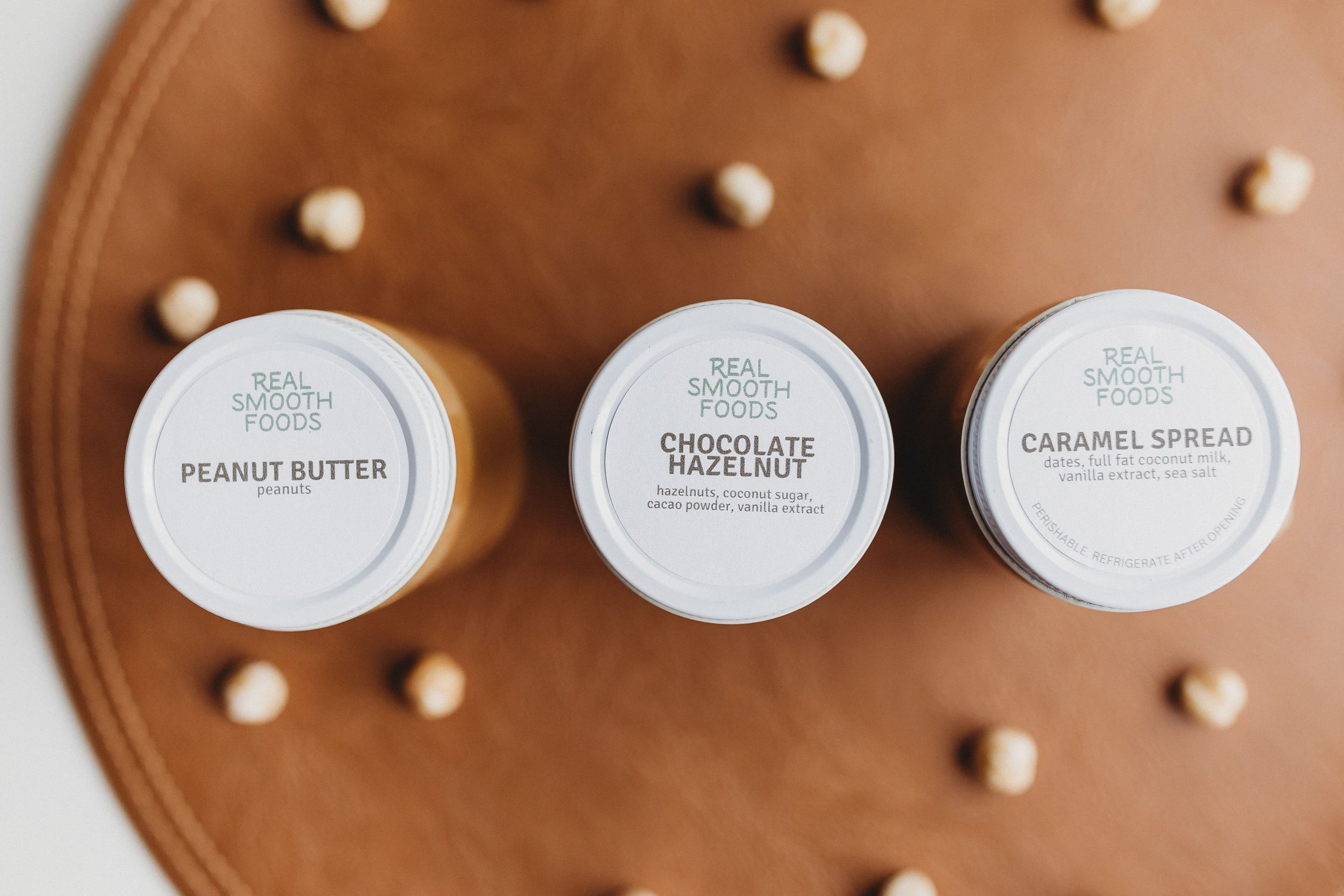  pb, chocolate hazelnut, and caramel spreads sit during a food product photography shoot 