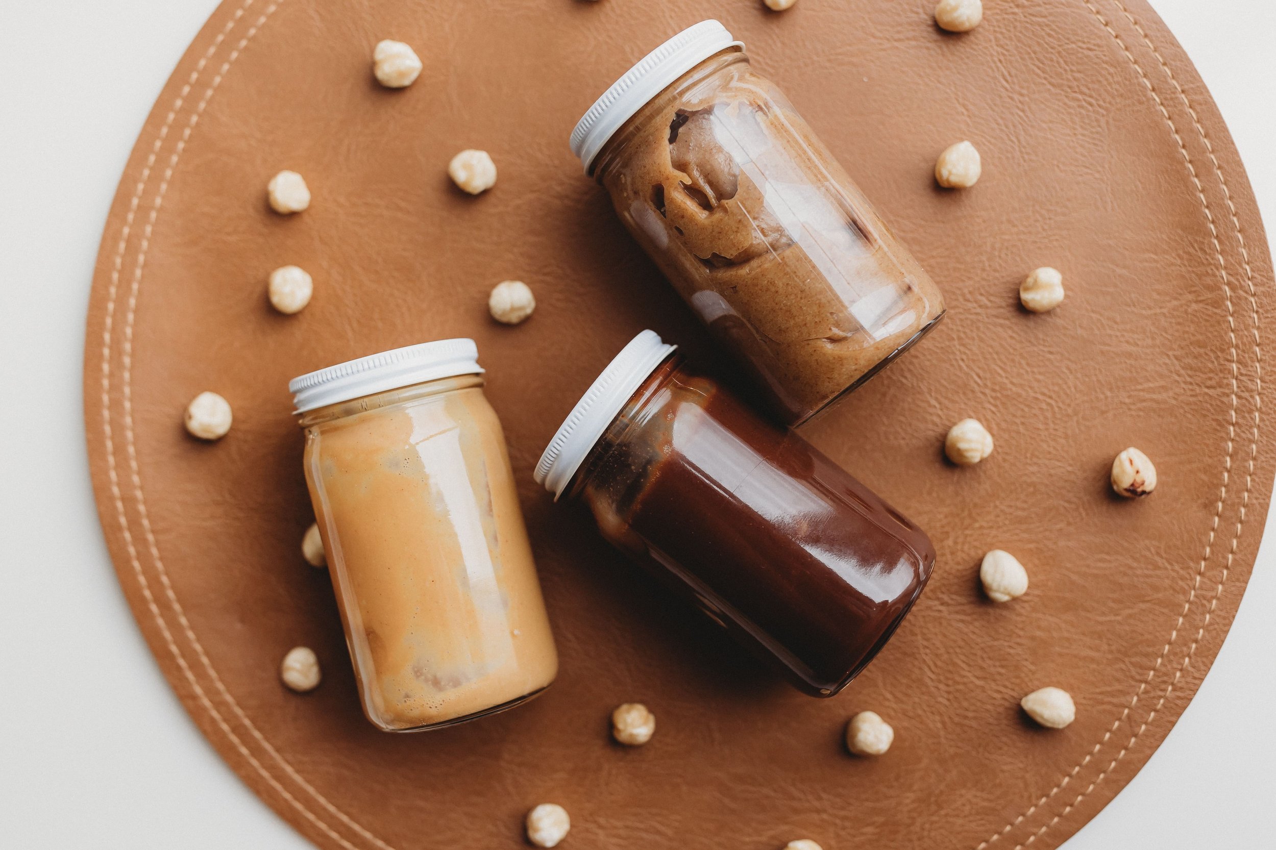  three jars of spreads sit during a food photo shoot 