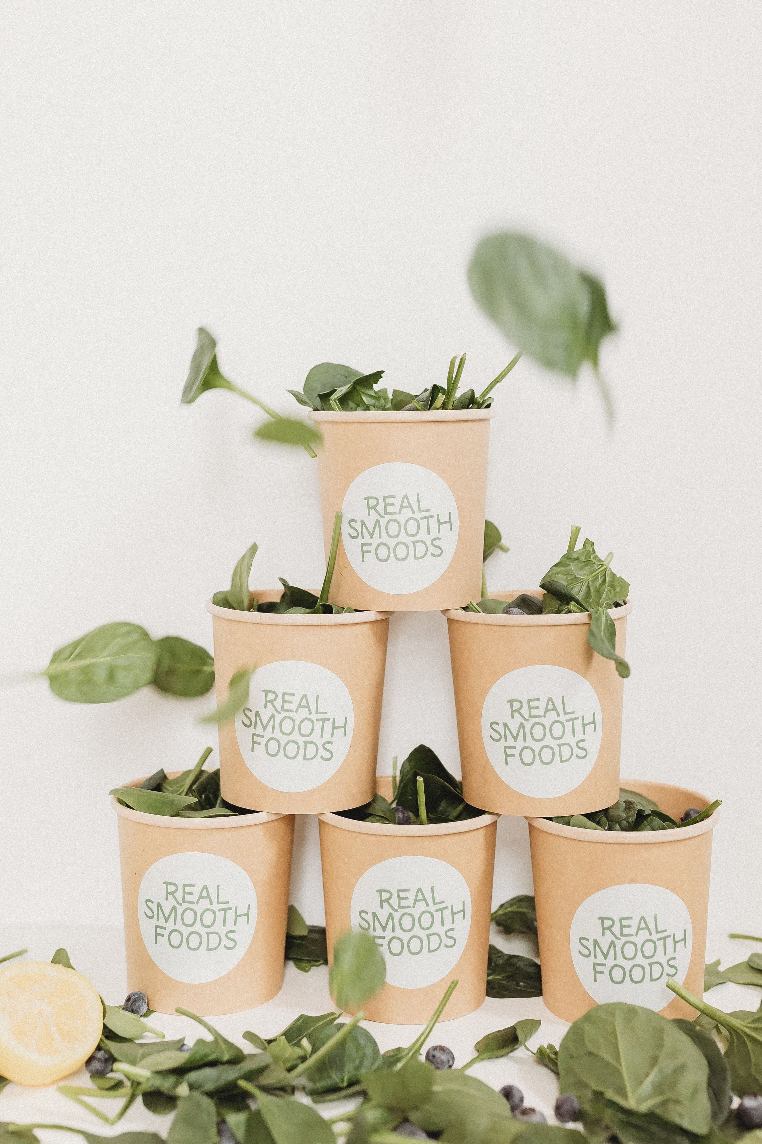  a stack of cups each full of spinach from real smooth foods brand shoot 