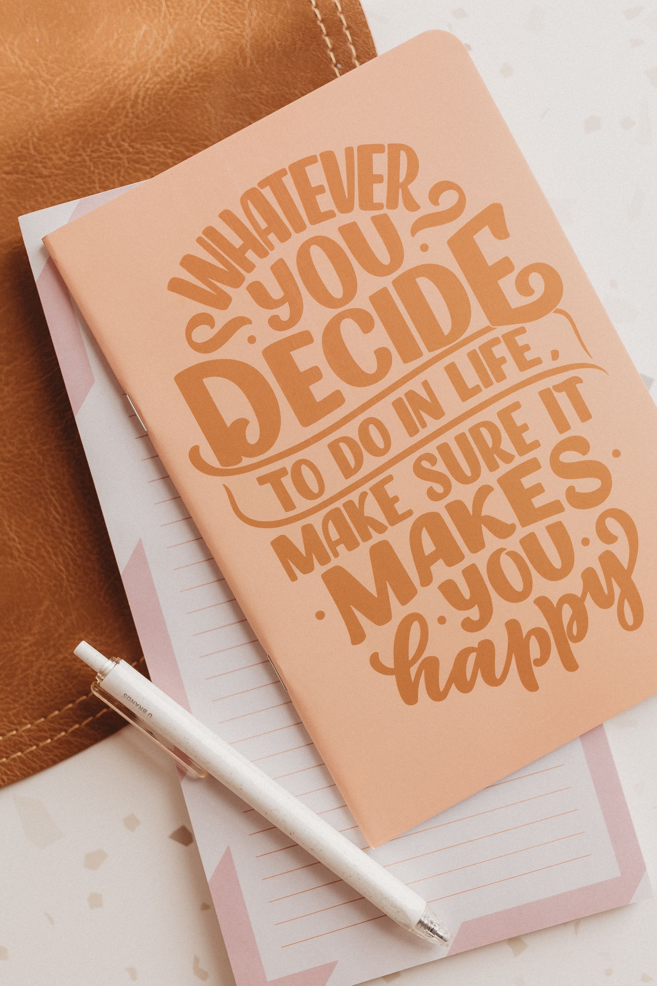  a notebook that says “whatever you decide to do in life, make sure it makes you happy” 