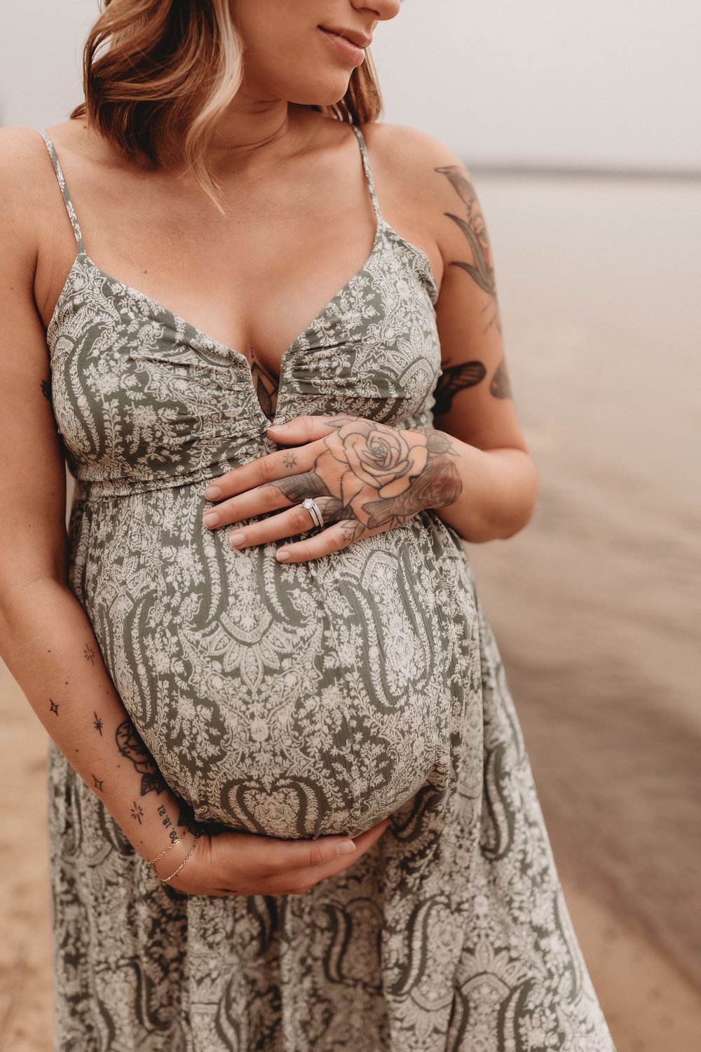  a pregnant woman rests her hands on her belly during a maternity shoot 
