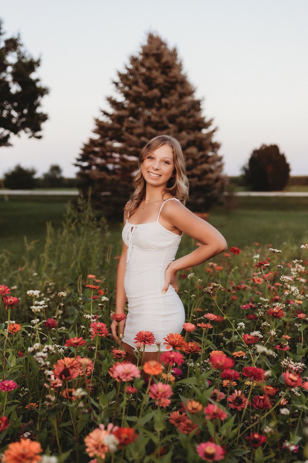  a senior photographer near me captured a young woman smiling in a flower field 