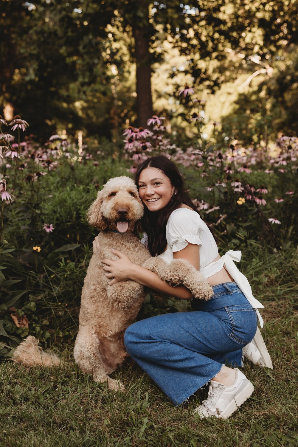  olivia and her dog pose for pictures in a grassy area 