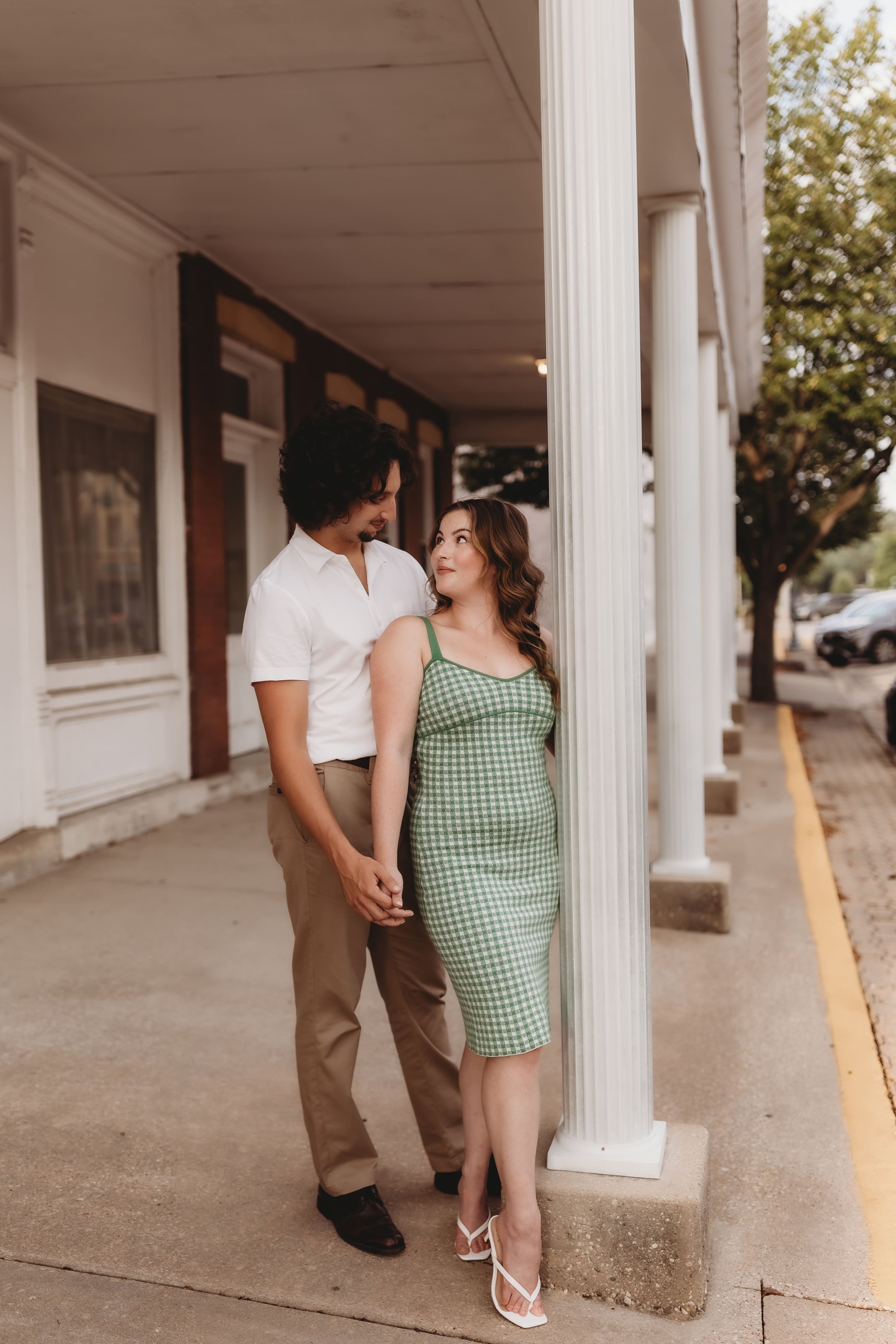  a couple stand together during their engagement photos 