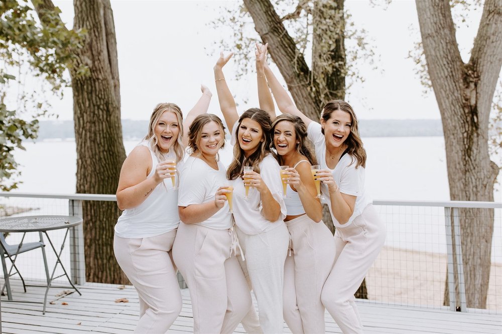  wedding recap, a photo of hannah and her bridesmaids in matching pink joggers and white tees 