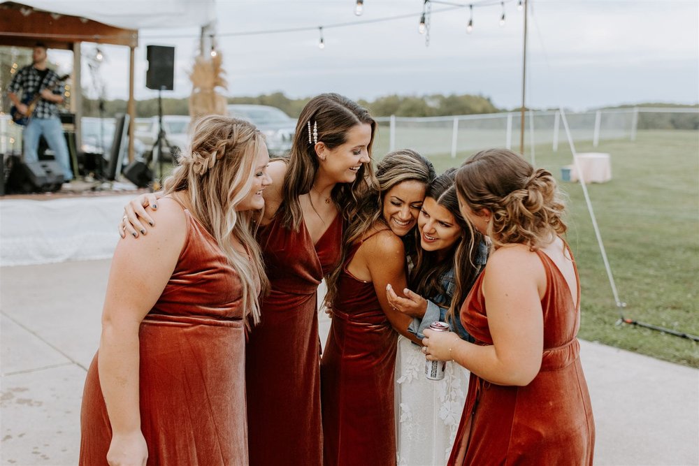  wedding recap, hannah shares a hug with her bridesmaids 