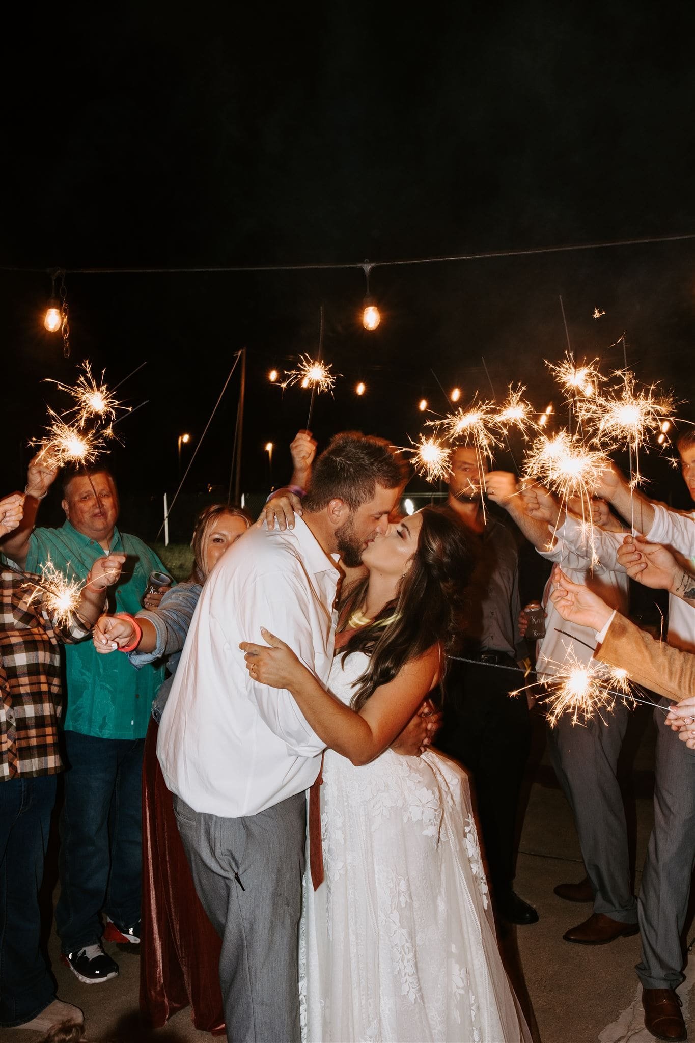  hannah and lance share a kiss during their sparkler send off 