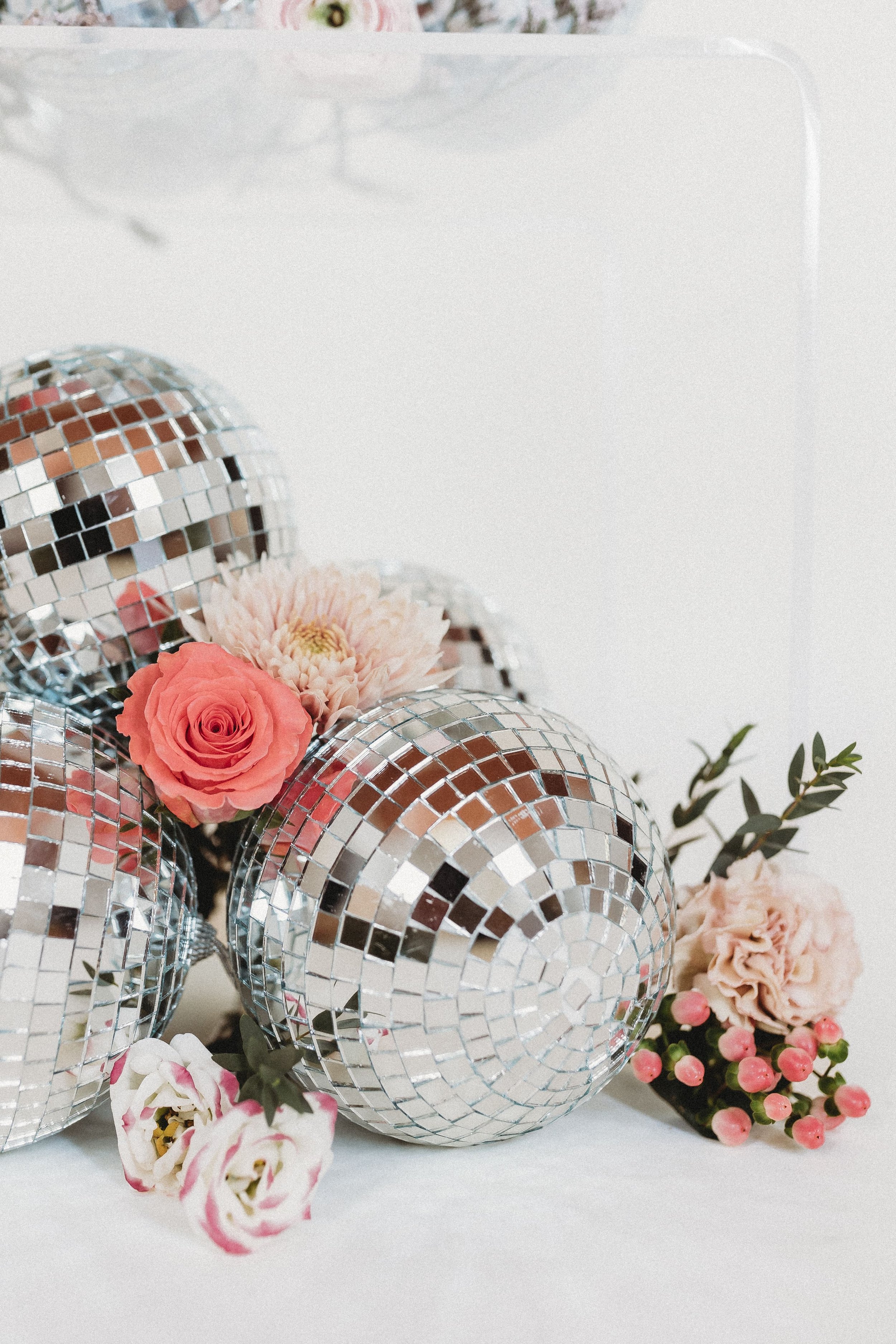  an arrangement of florals and disco balls for business branding photography 