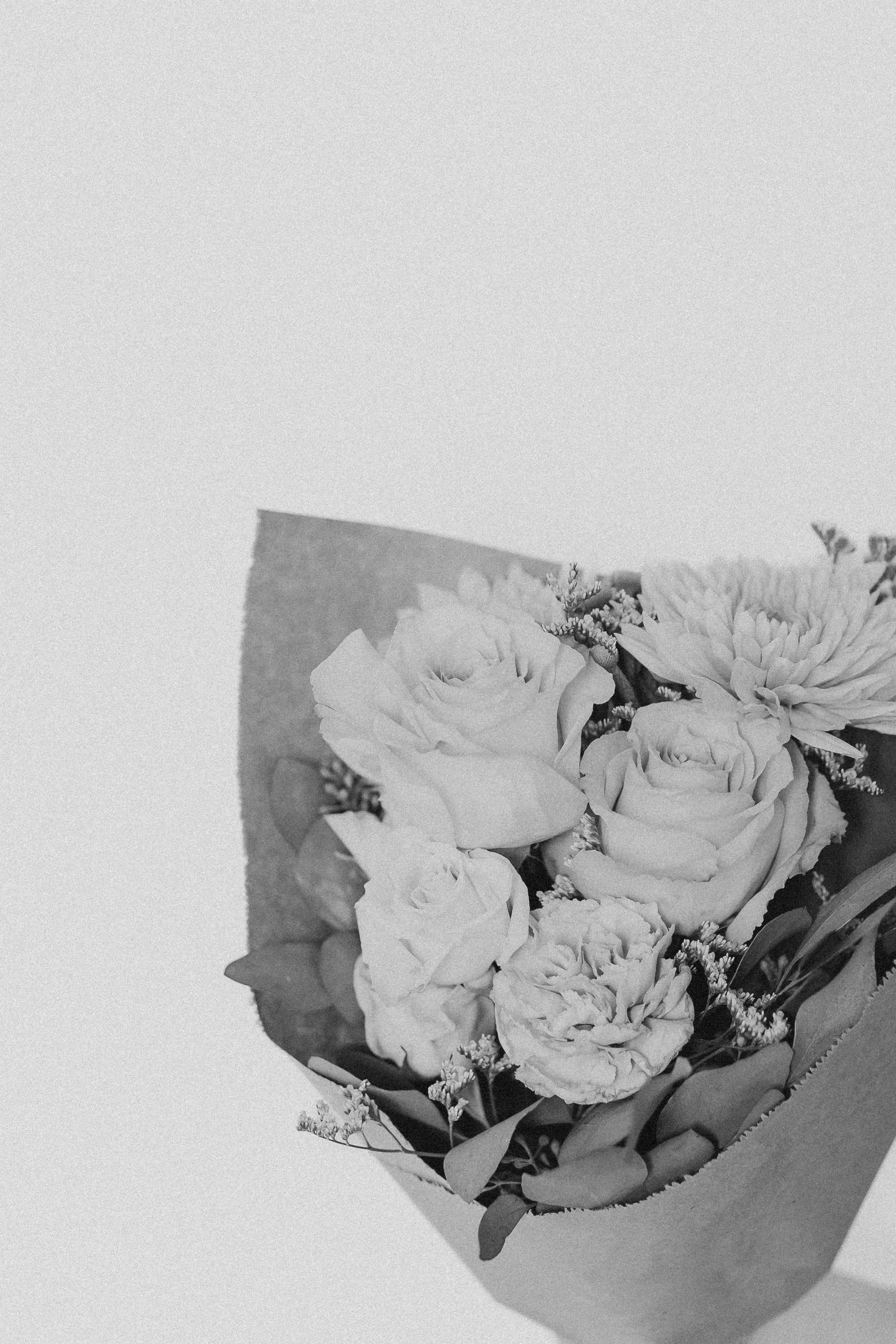  a black and white photo of a hand tied bouquet of flowers 