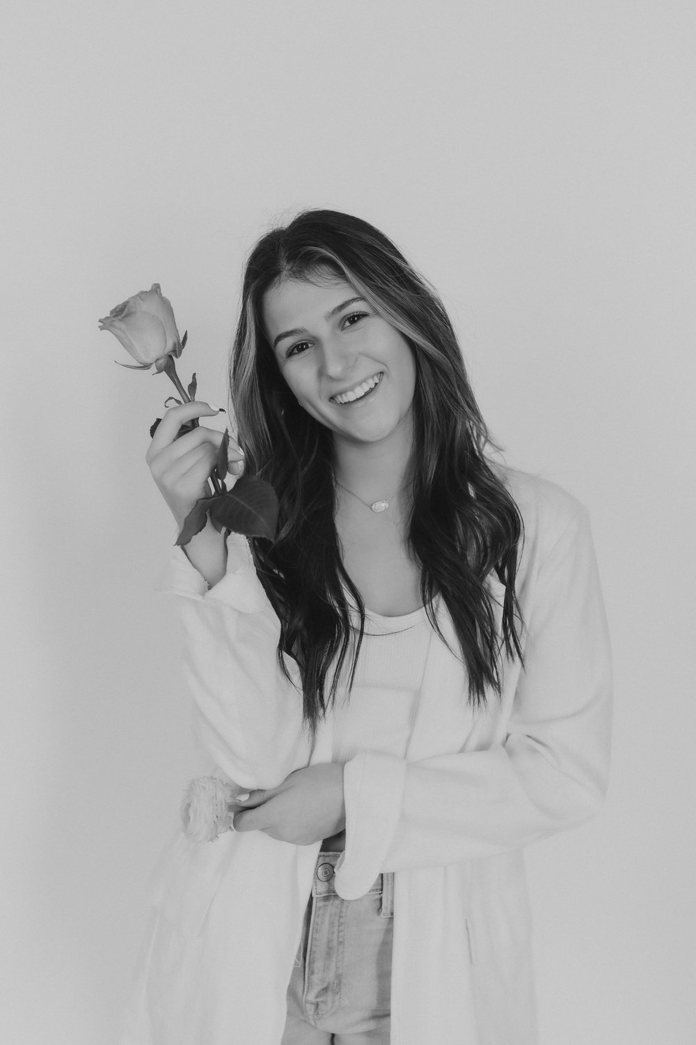  for business branding photography a woman smiles holding a single rose 