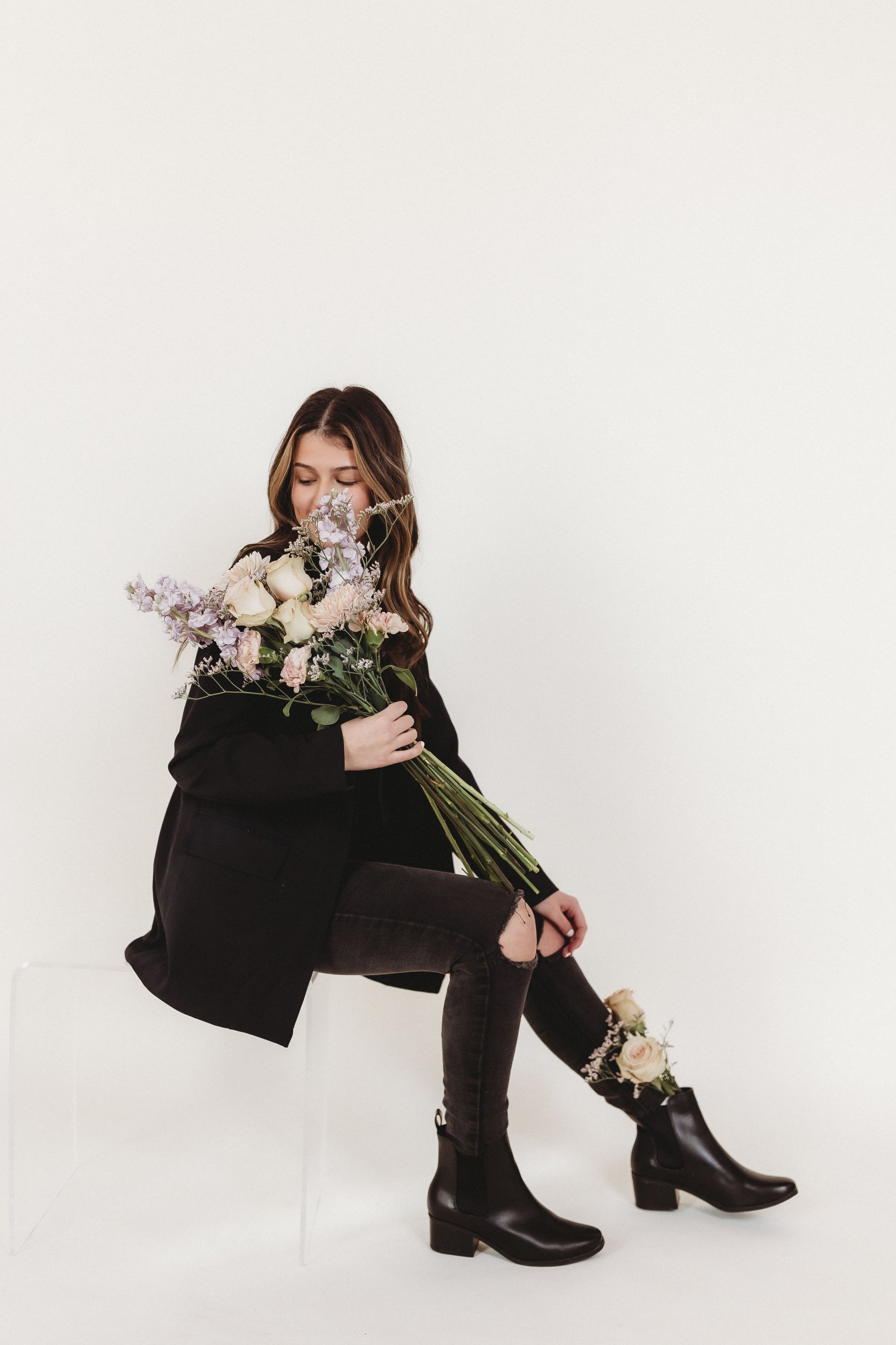 for floral business branding photography a woman sits and smells the flowers she holds 