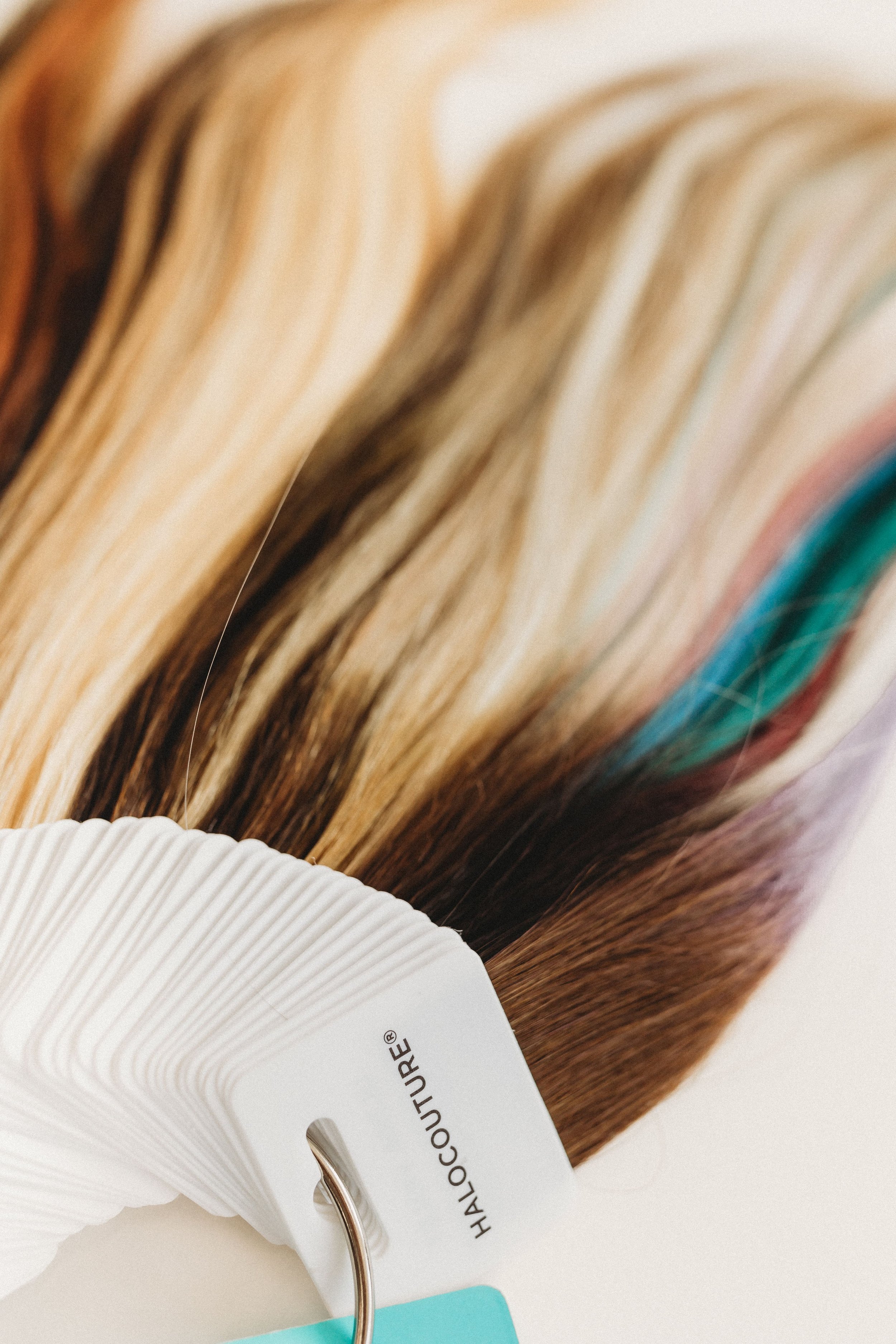  a set of hair color samples sit on a ring during a stylist photo shoot 