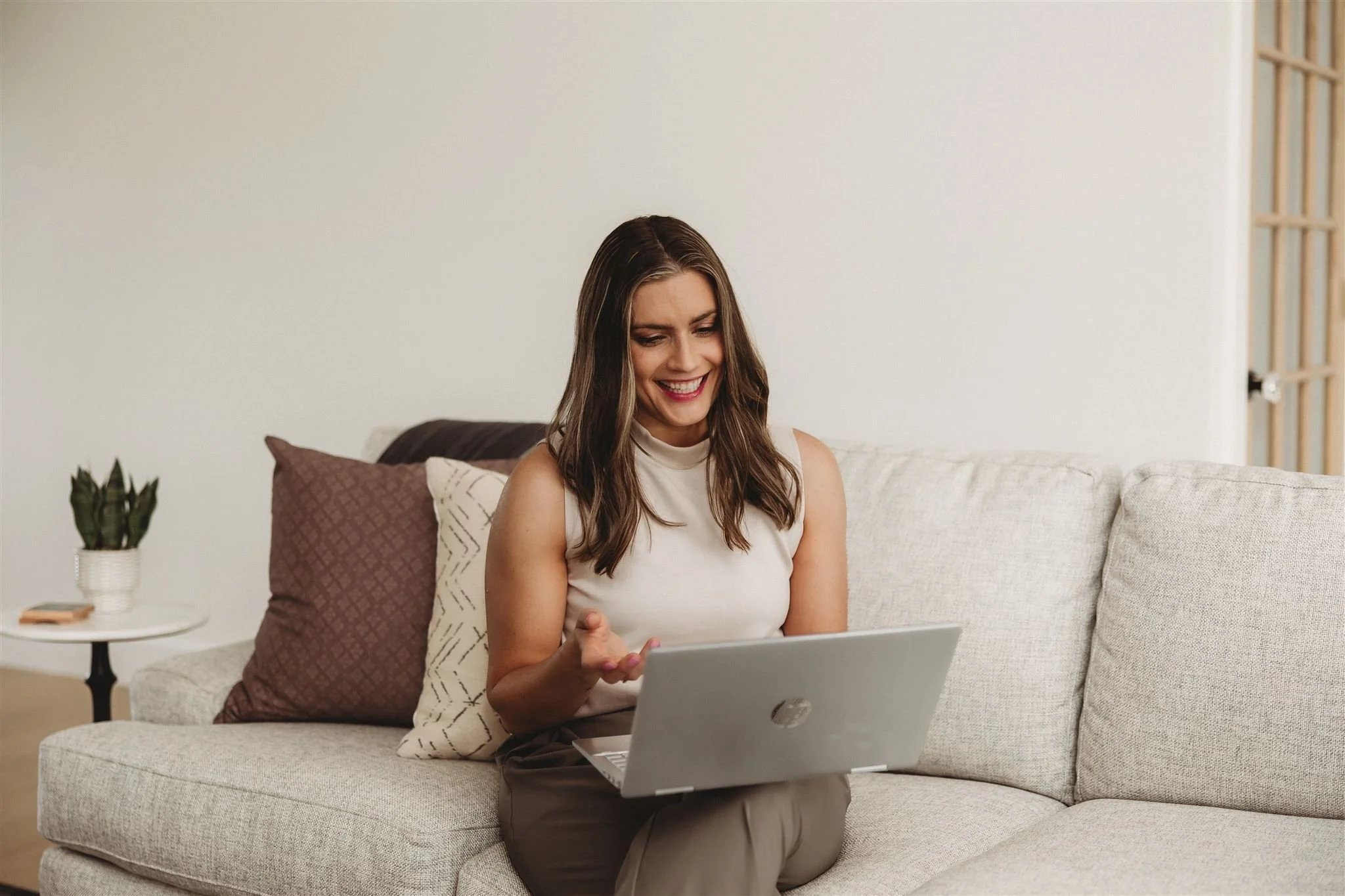 A Vitality Physical Therapy and Wellness physical therapist smiling during an online virtual physiotherapy consultation, offering accessible telehealth and remote pelvic floor or prenatal physical therapy services from the comfort of home.