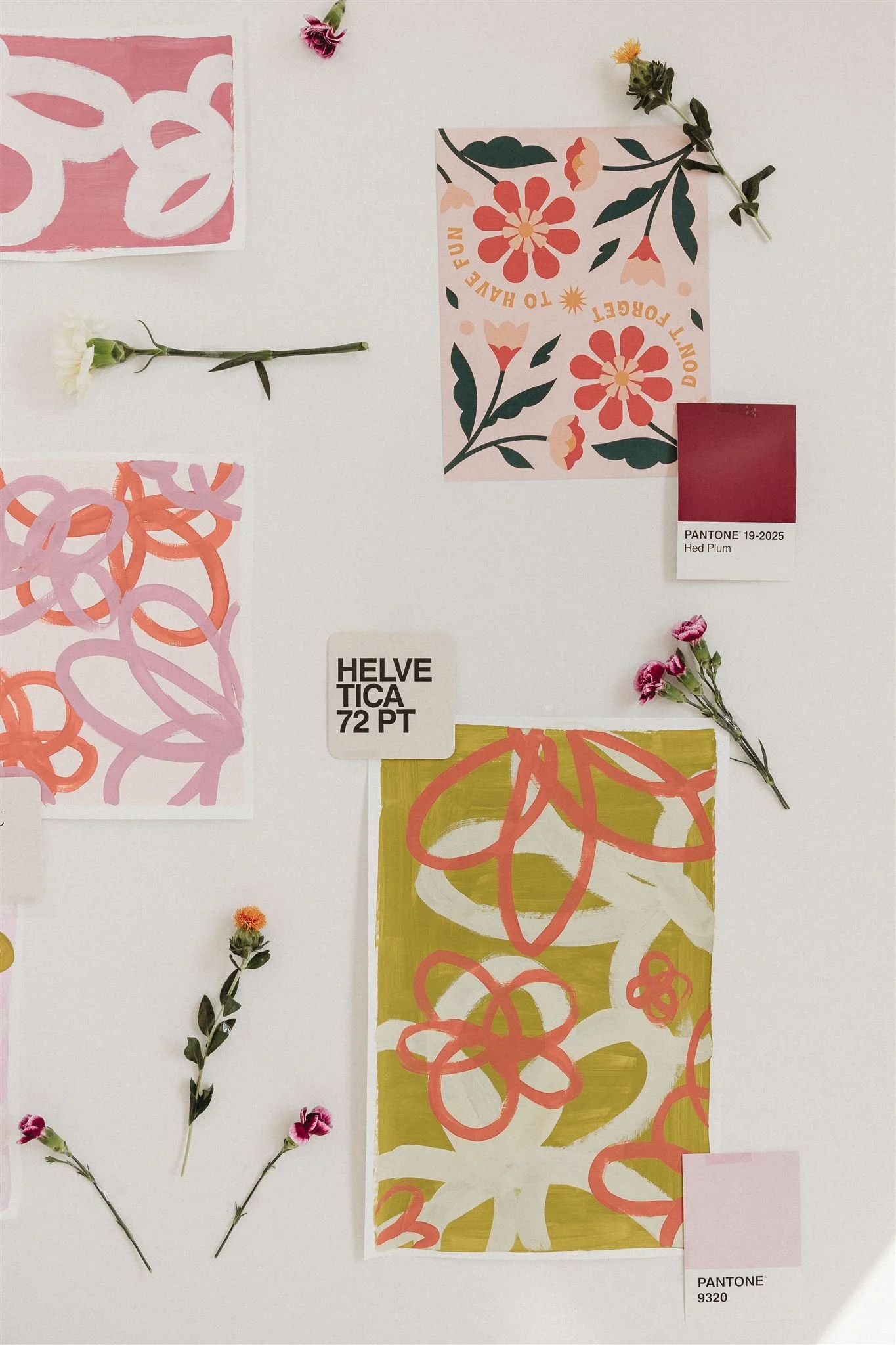 Collage of floral patterns and paint swatches with labeled color samples, including a Pantone Red Plum sample, on a white background. Small flower sprigs are placed around the patterns.