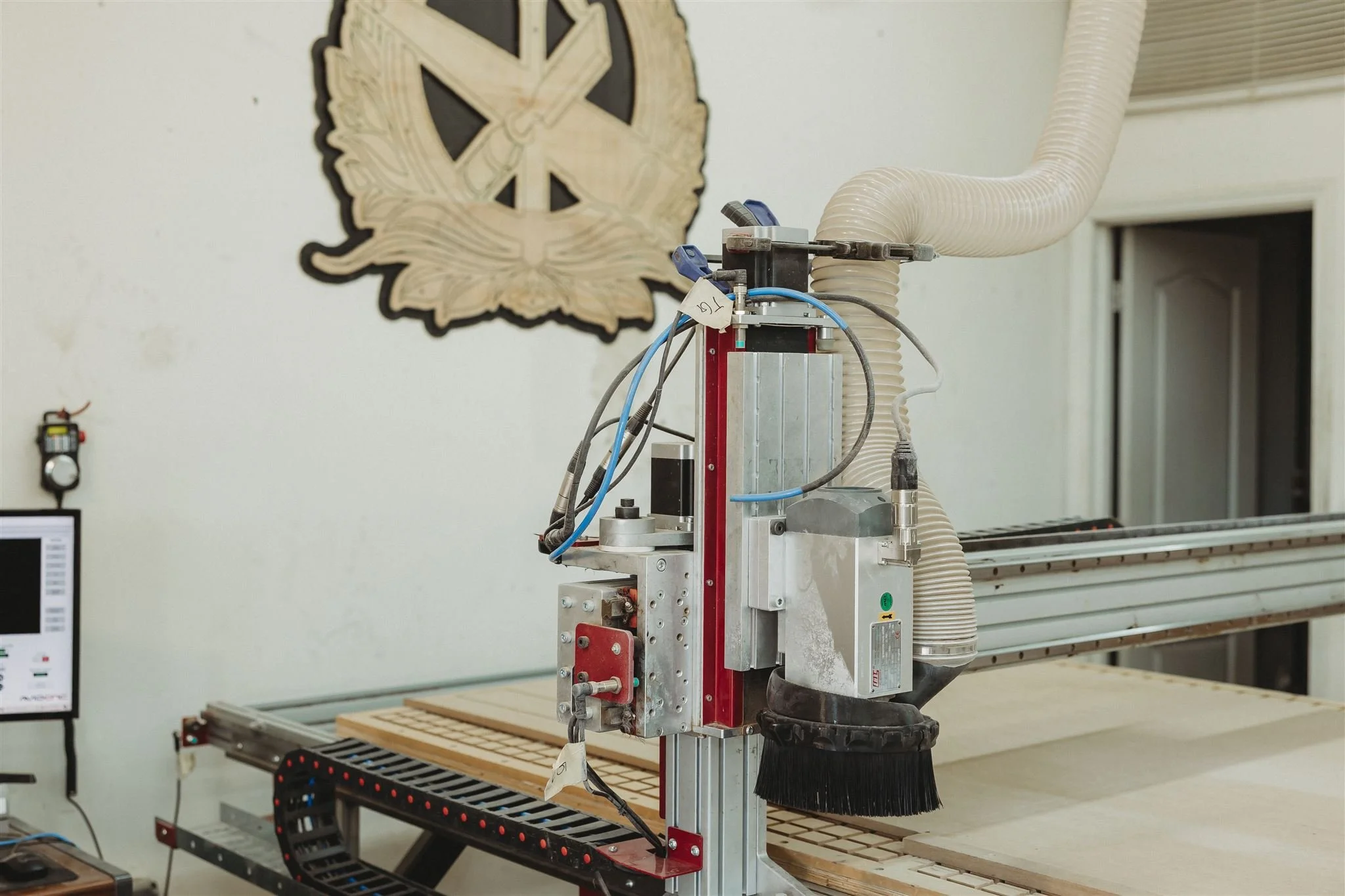 Walters Woodworking's CNC router machine precision-cutting custom wood components in their production facility, showcasing their advanced woodworking technology and capability for high-quality custom cabinetry and millwork fabrication.