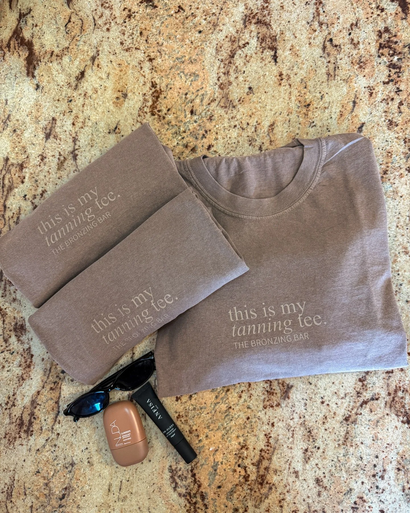 Tanning tees now available in store for $44.

The piece you didn&rsquo;t know you needed until now.
Throw it on post-spray, post-workout, or when you didn&rsquo;t plan ahead and still need to look put together.

Oversized, easy, and made for fresh ta