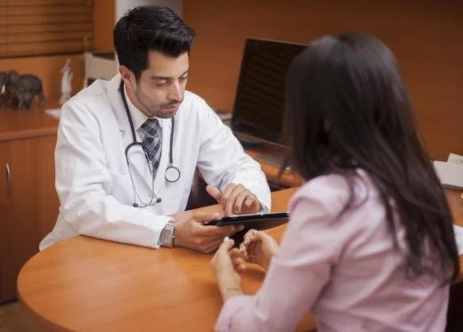 Doctor consulting with a patient in an office setting.