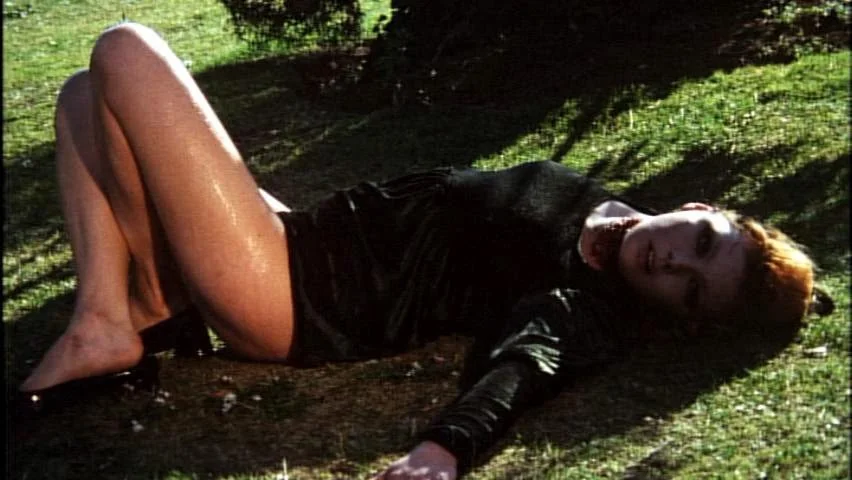 A body lies on the grass in A Bay of Blood