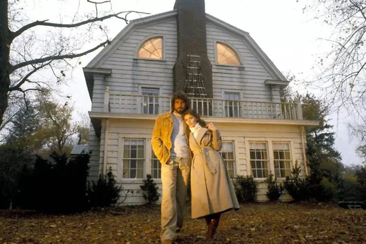 The Lutz's stand outside their house in Amityville, NY