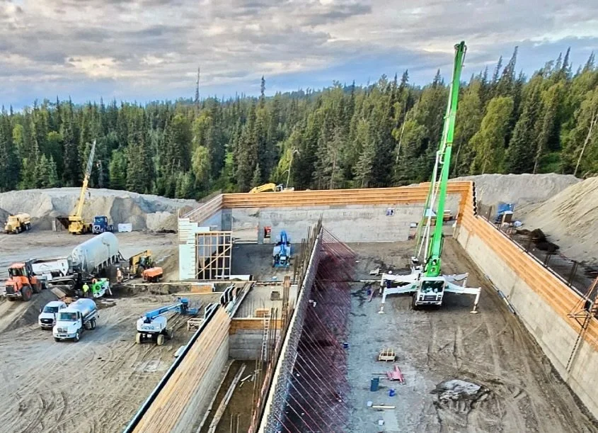 Behind each ICF wall is a finely tuned choreography of concrete:

🔸 The Cementech C60 volumetric mixer is fed cement powder by the bulk Guppy trailer and water by a tanker truck.
🔸 The orange loader delivers &frac34;&rdquo; minus aggregate.
🔸 Once
