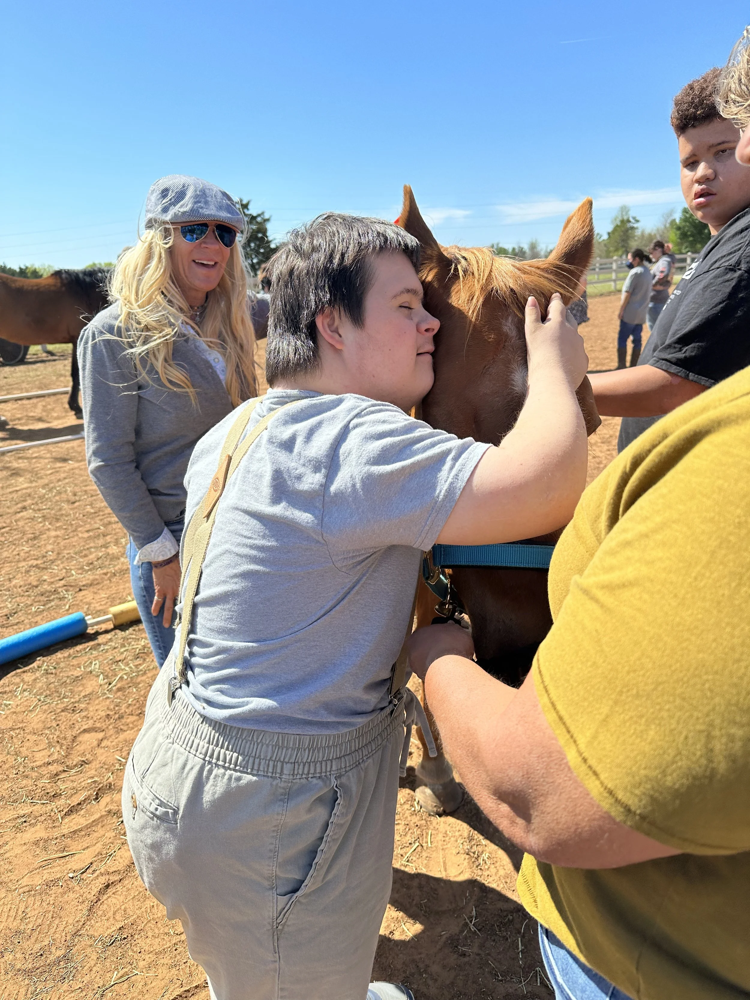 hippotherapy sweet boy hugging pistol.jpeg