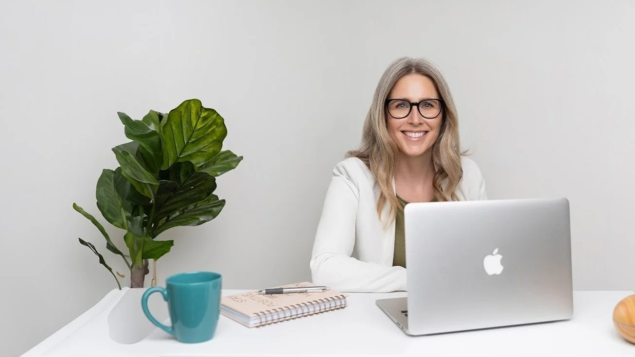 A professional counselor at desk with laptop
