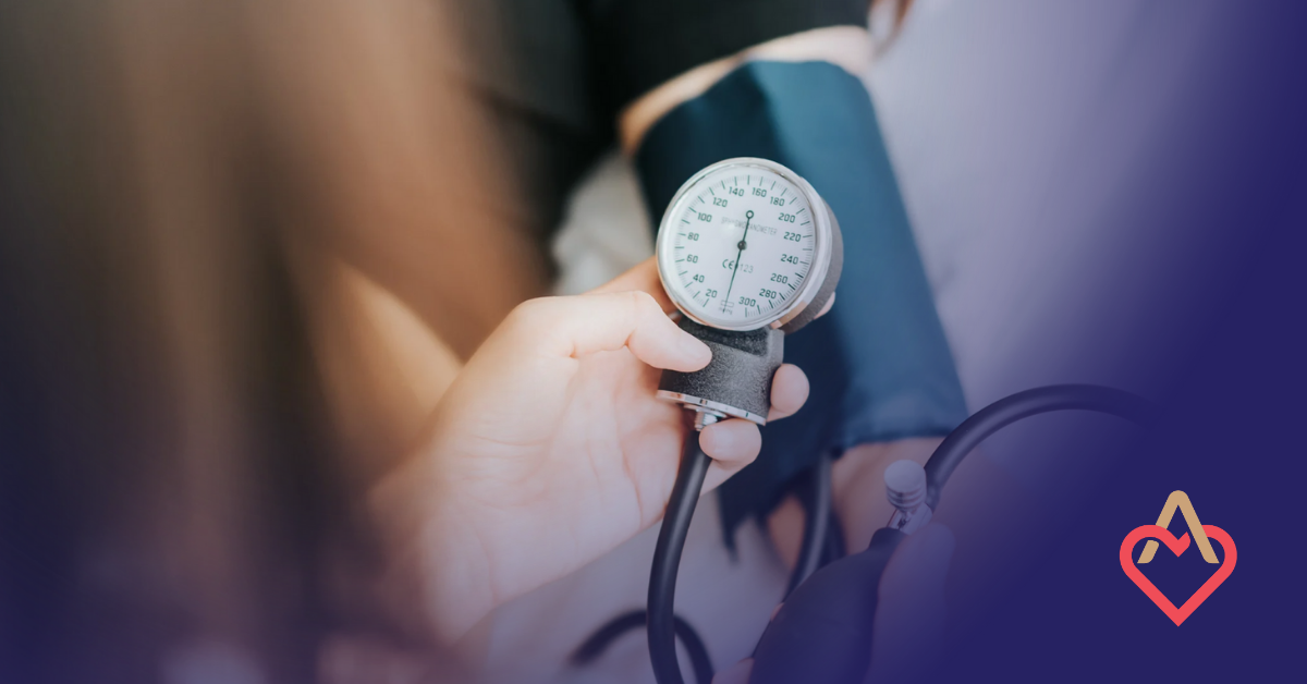 Person measuring blood pressure with a sphygmomanometer on a patient's arm.
