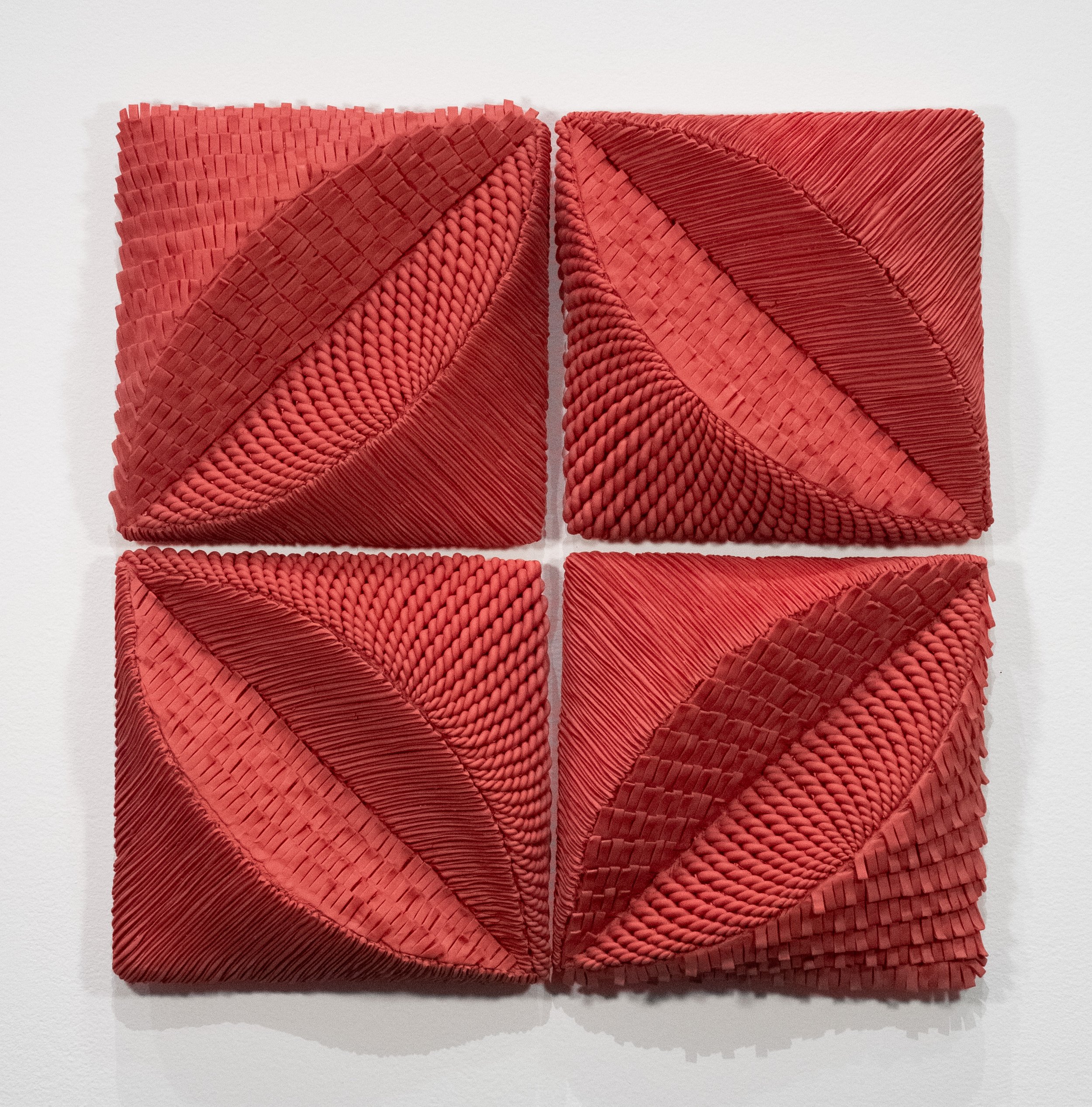 Four ceramic quilt blocks translated from the Cathedral Window pattern ...