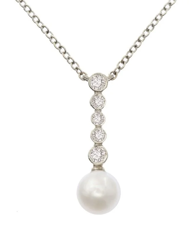 White gold necklace with five diamonds and a pearl pendant.