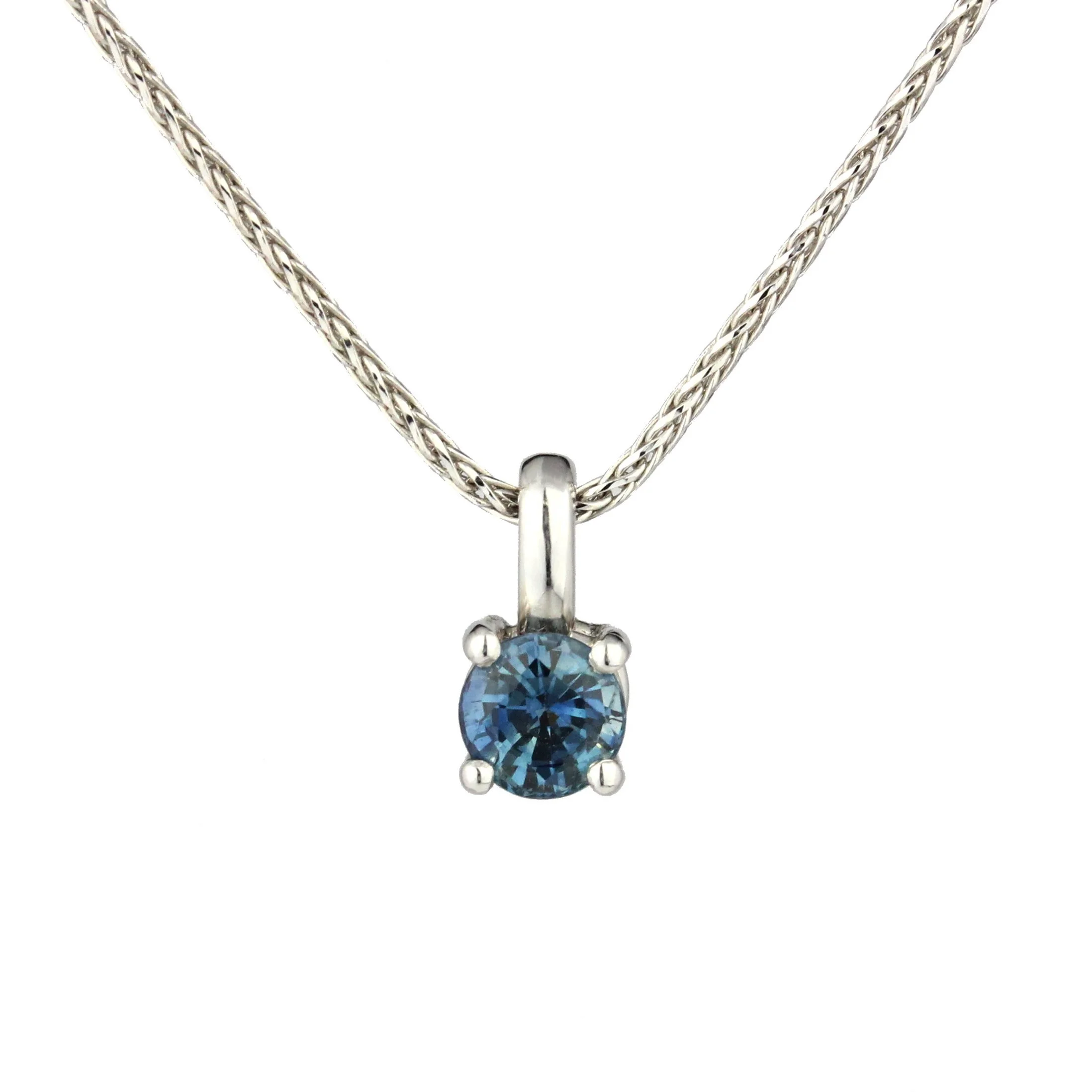 White gold necklace with round blue gemstone pendant.